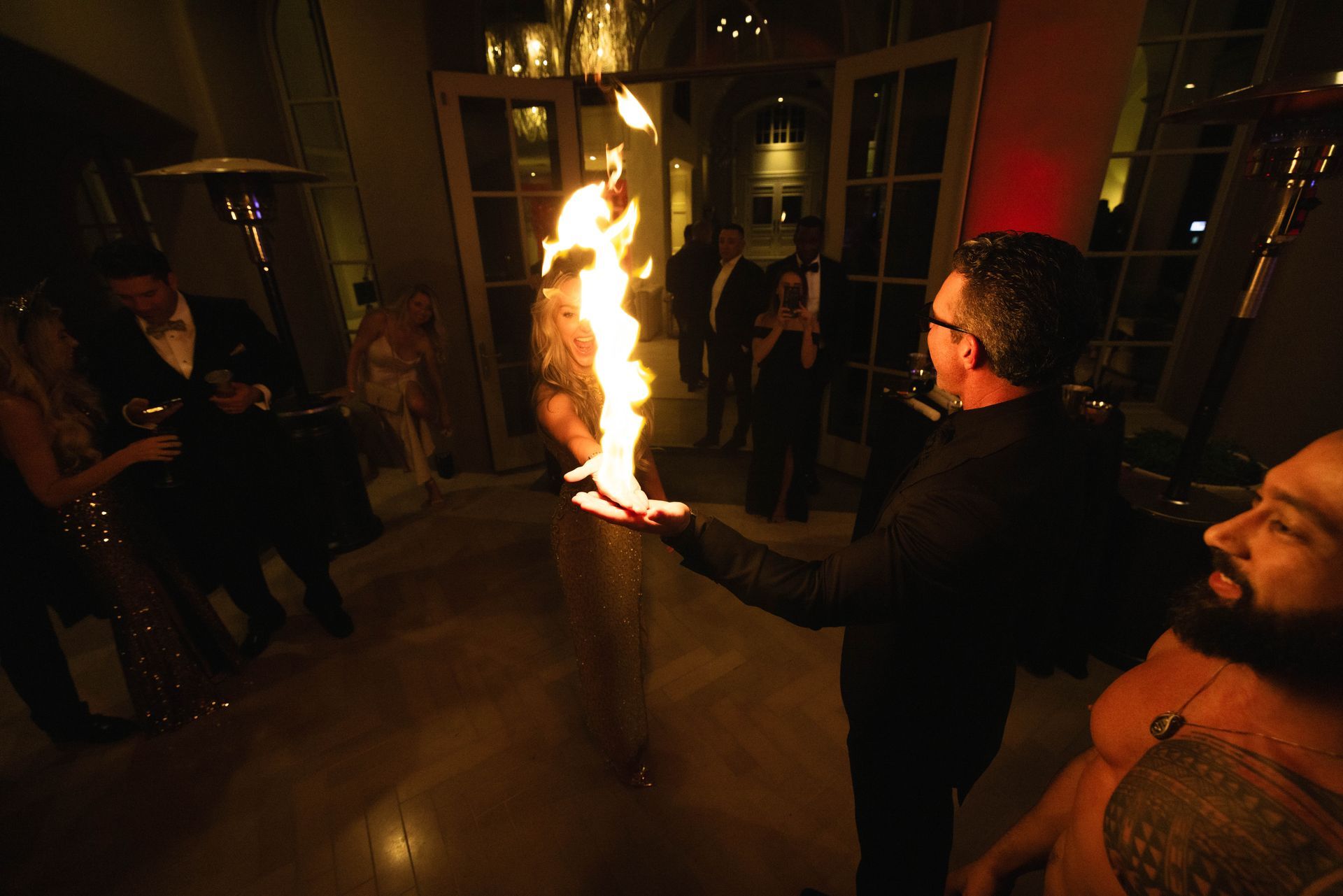 A man is holding a torch in his hand in a dark room.