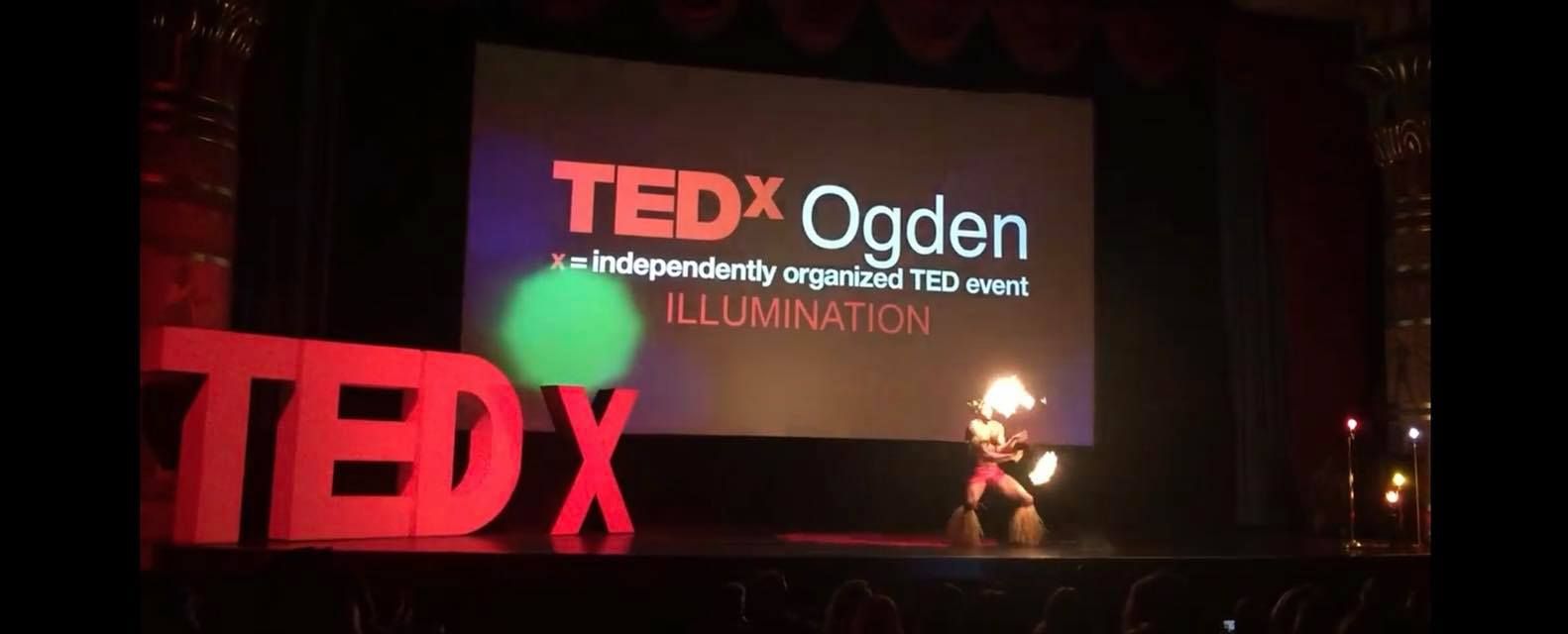 A tedx ogden event is being held in a dark auditorium