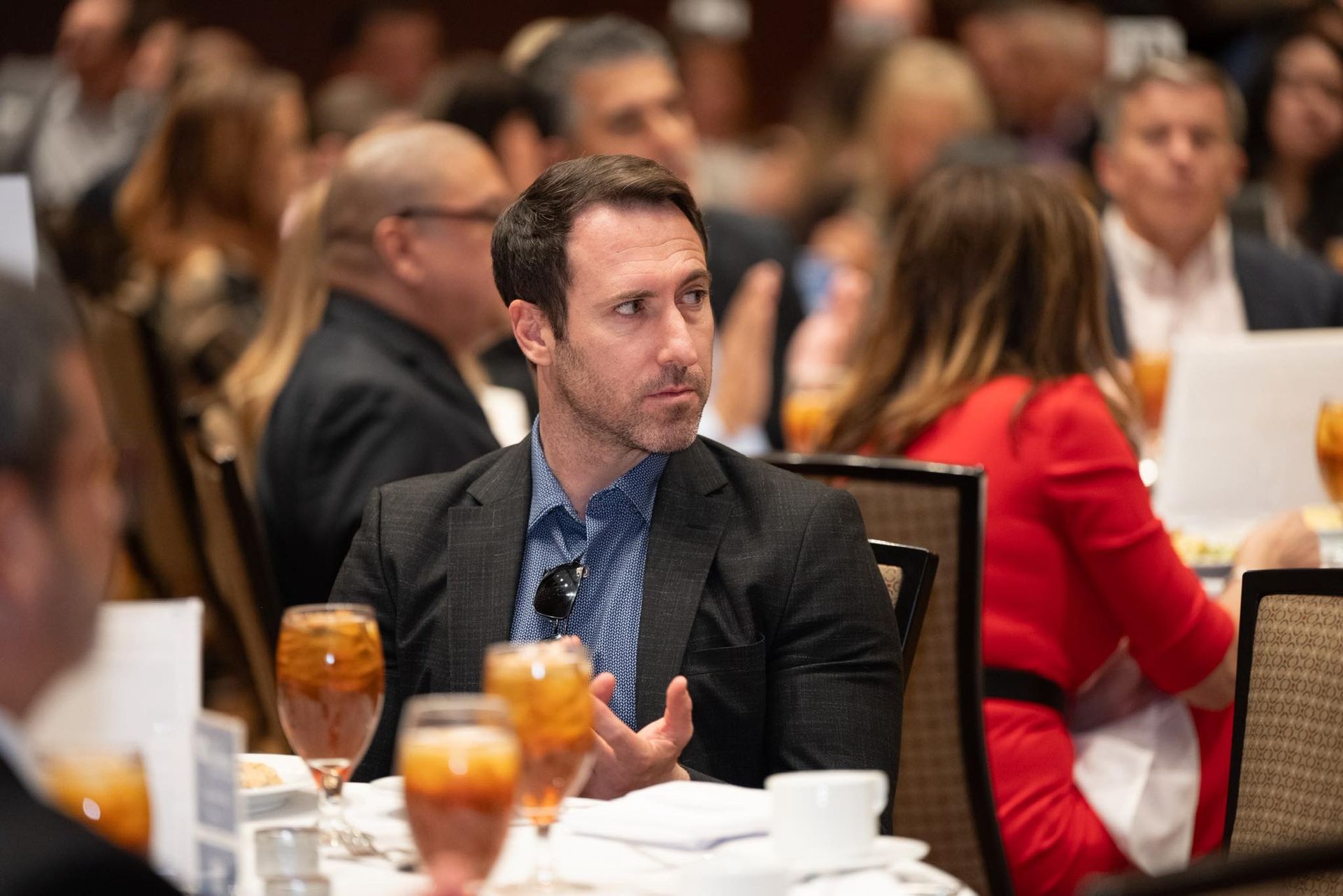 A group of people dressed in hawaiian costumes are posing for a picture.