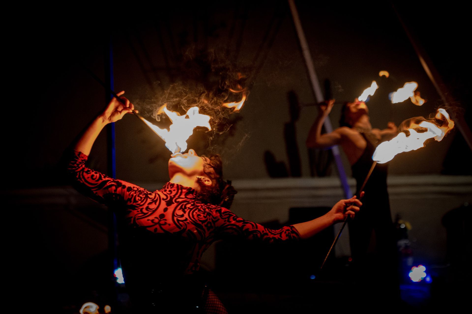 A woman eating fire for a performance.
