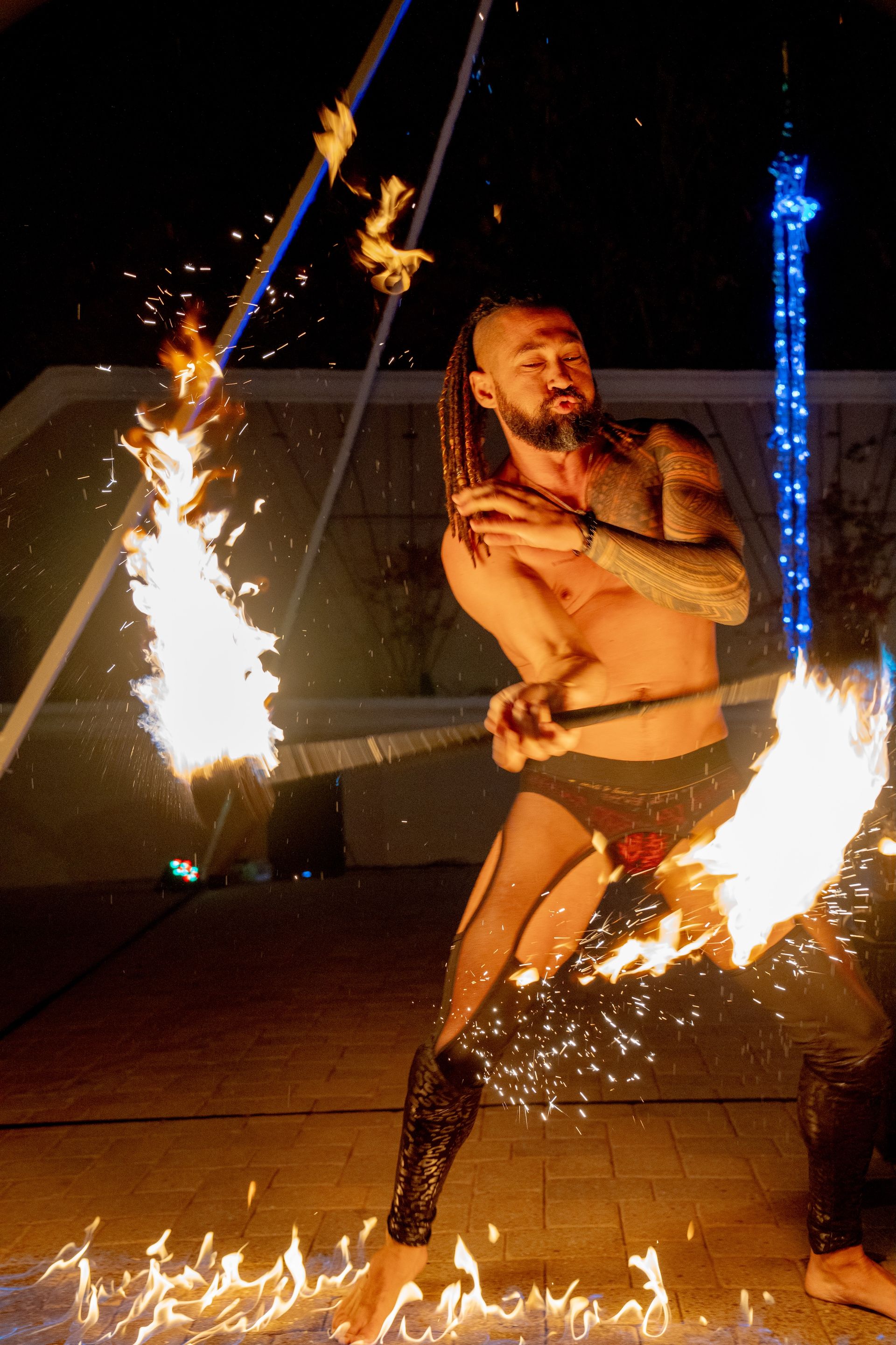 A man spinning fire in a performance.
