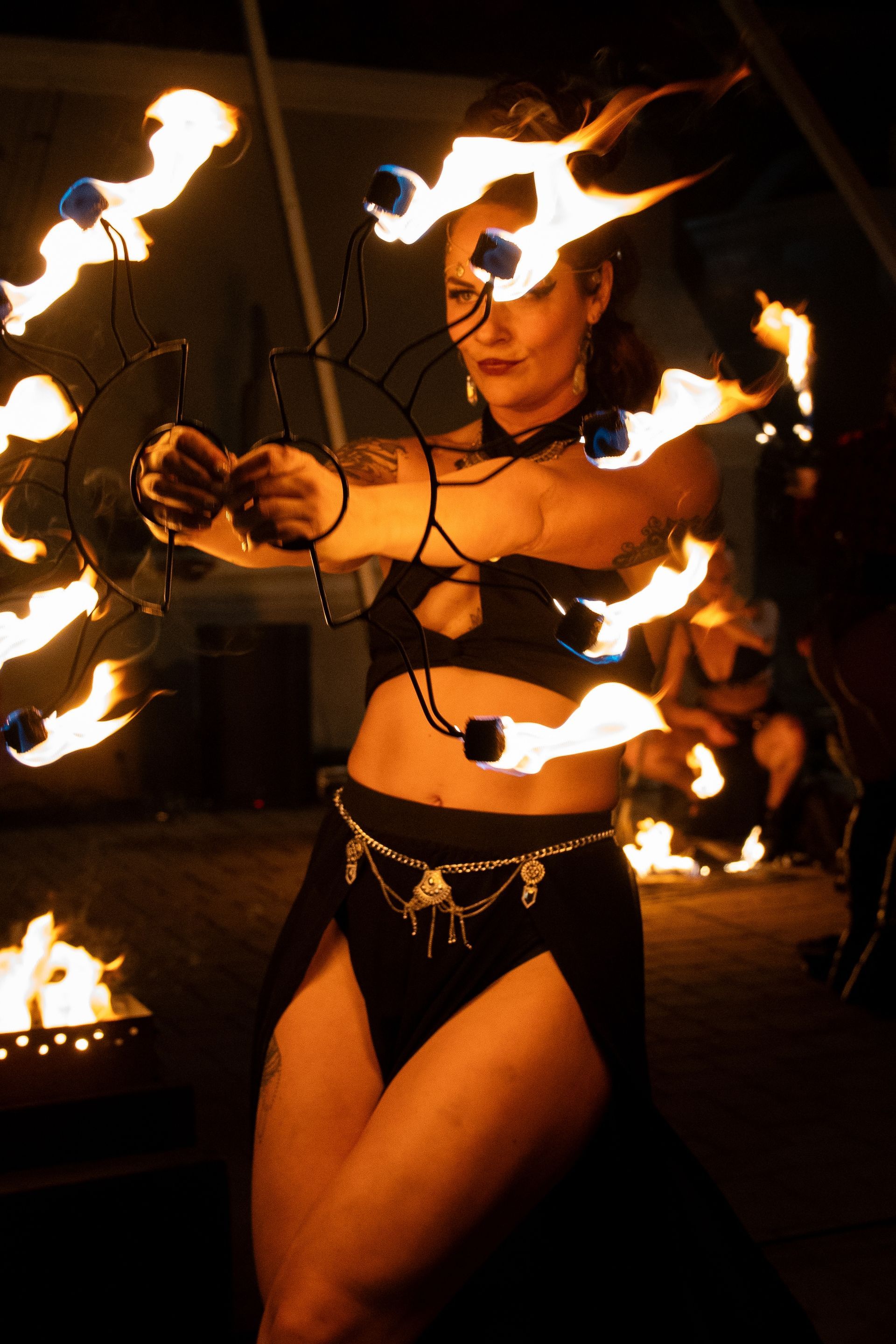 A woman is holding a bunch of fire in her hands.