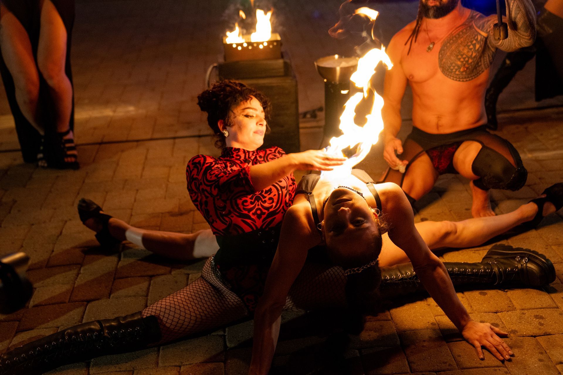 A woman safely lighting the chest of another woman.