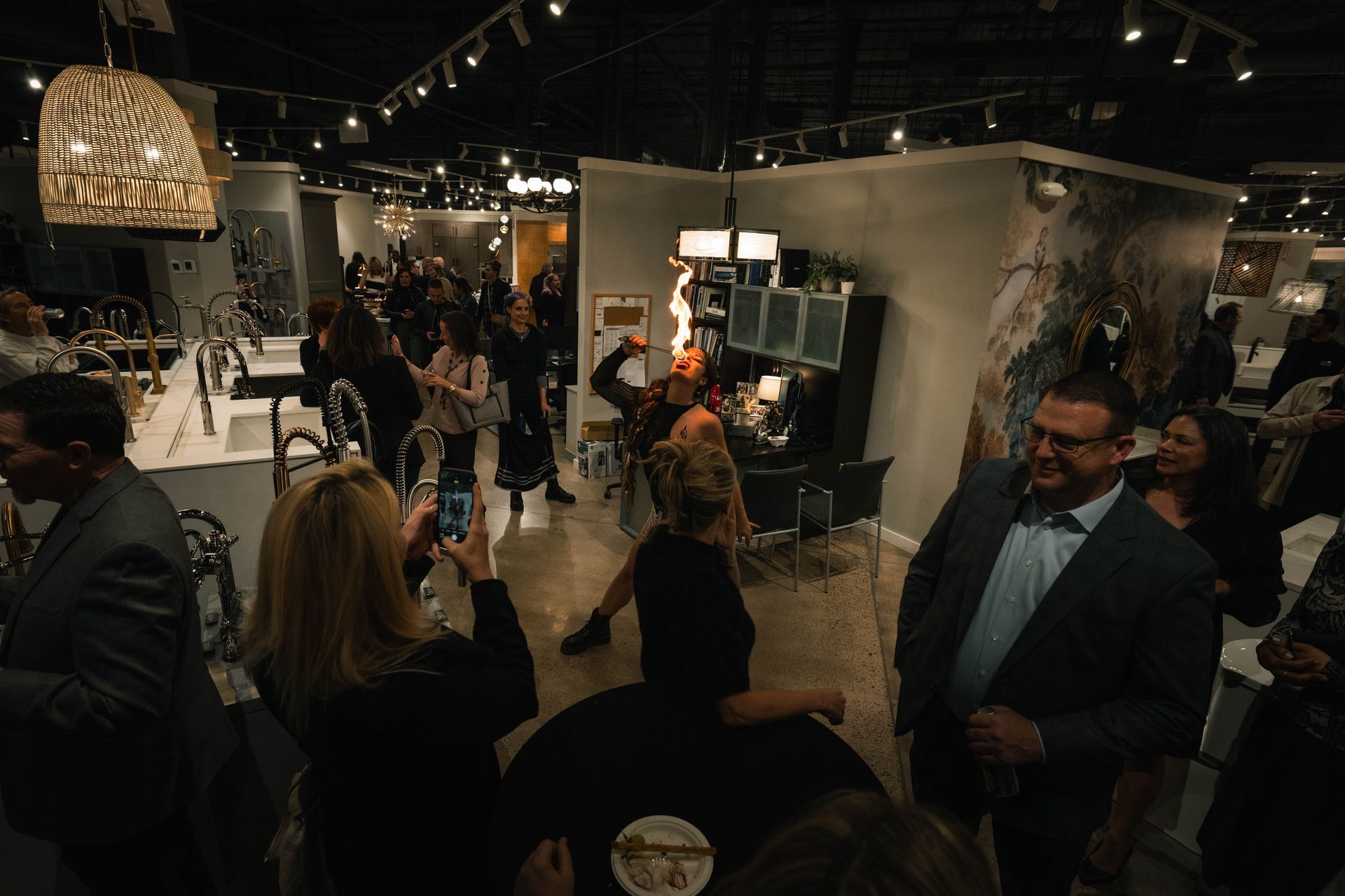 A large group of people are standing in a room.