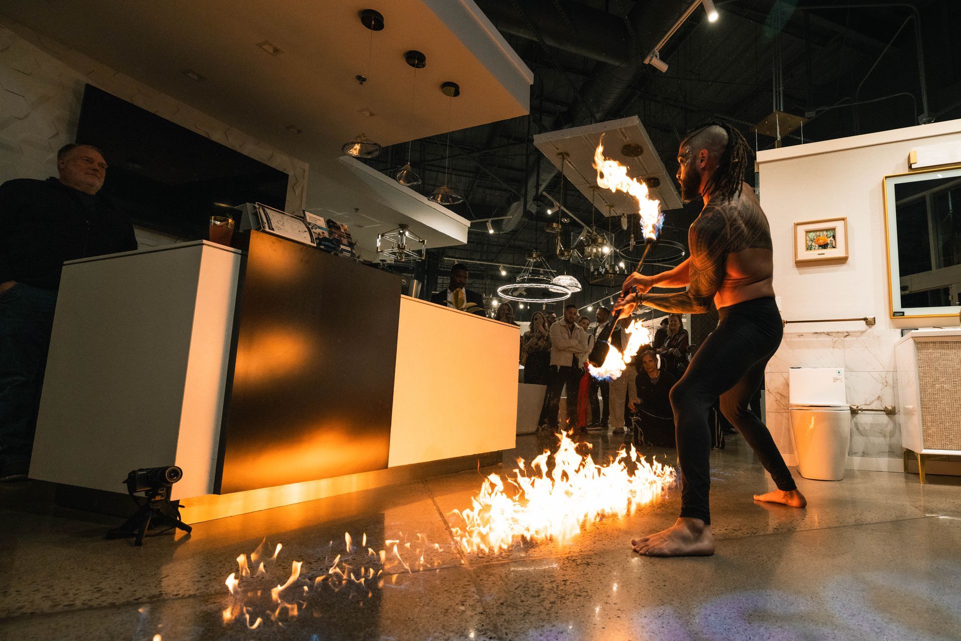 A group of people are playing with fire in a room.