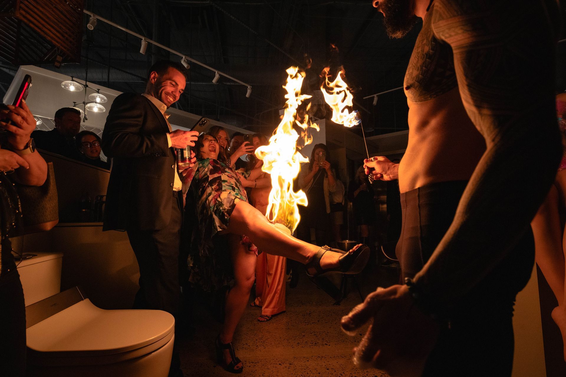 A man lighting the leg of a woman on fire.