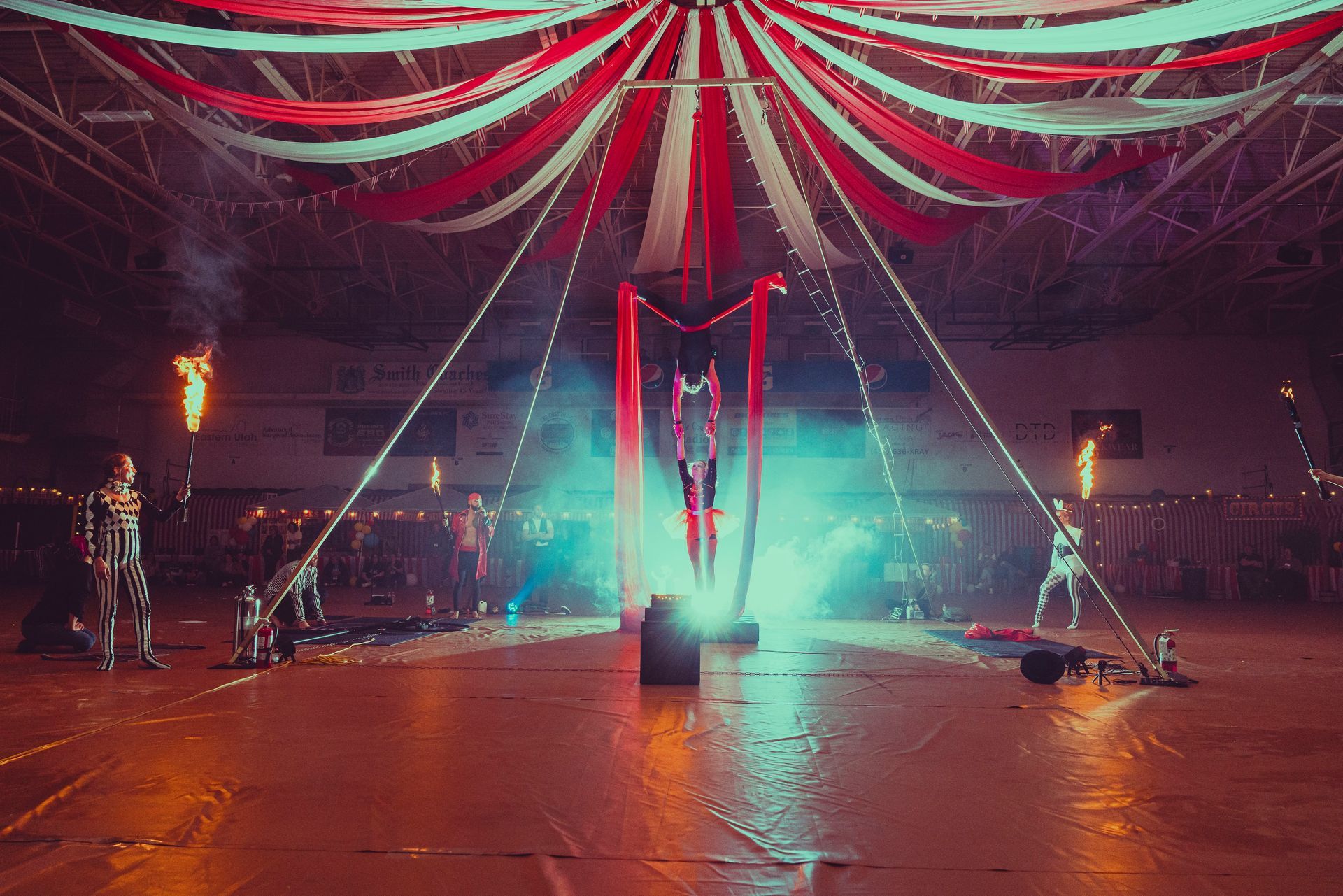 A group of people are performing a circus show in a stadium.