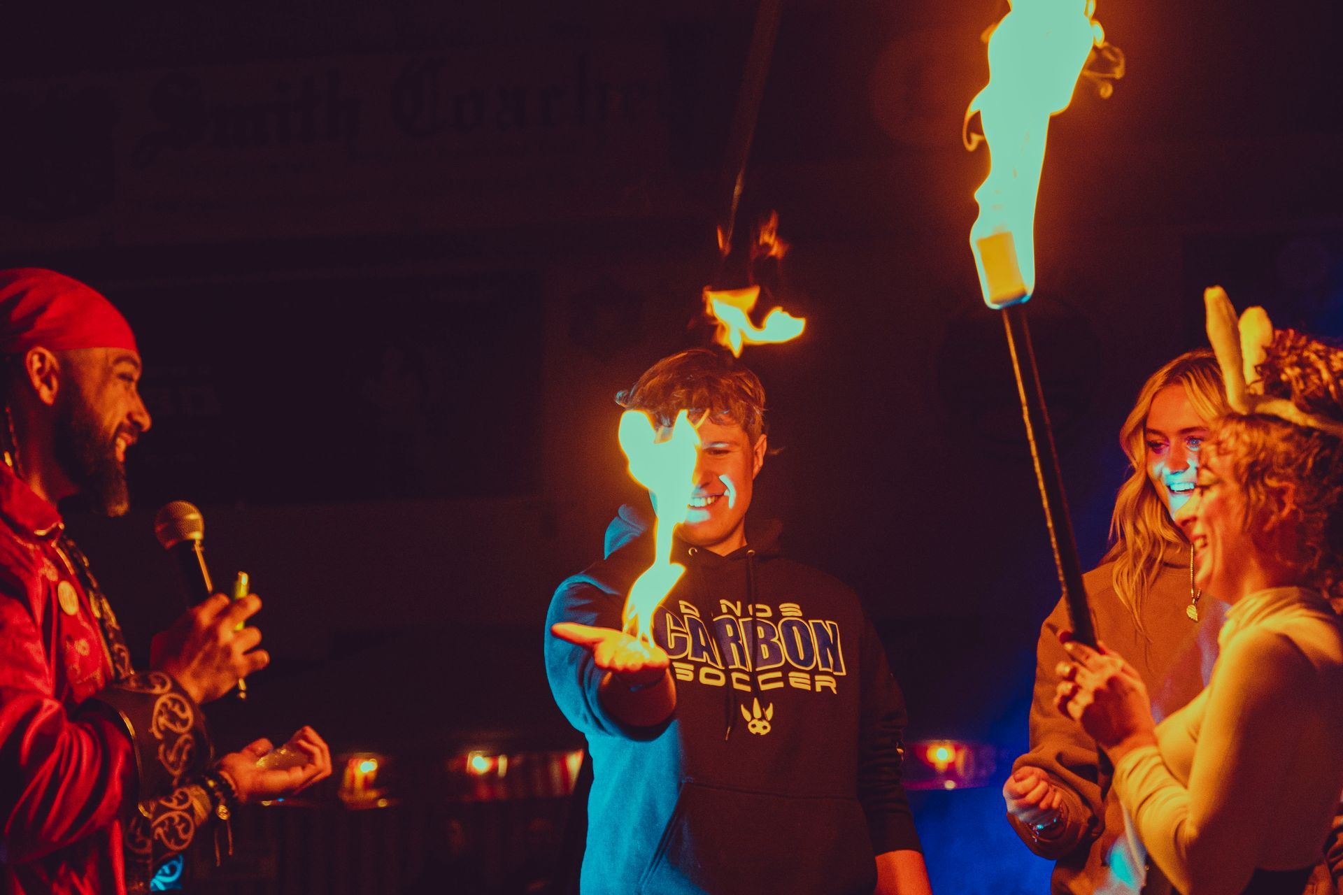A man is holding a torch in front of a group of people.