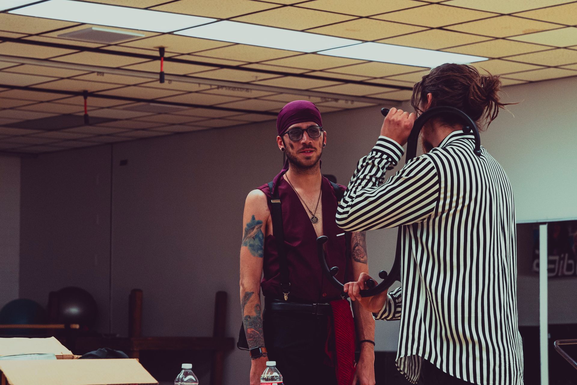 A man is taking a picture of another man in a room.