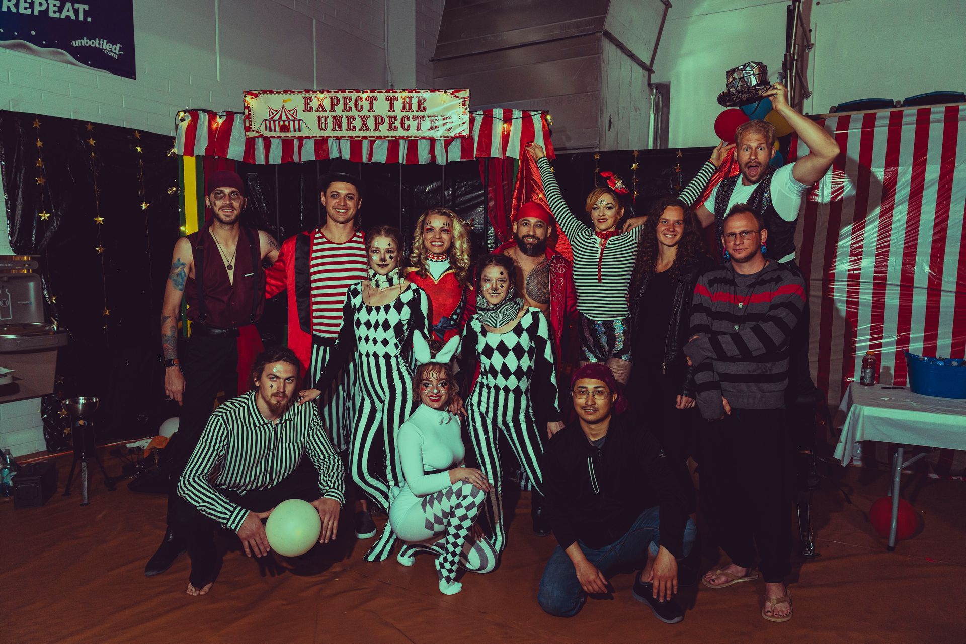 A group of people are posing for a picture in a room.
