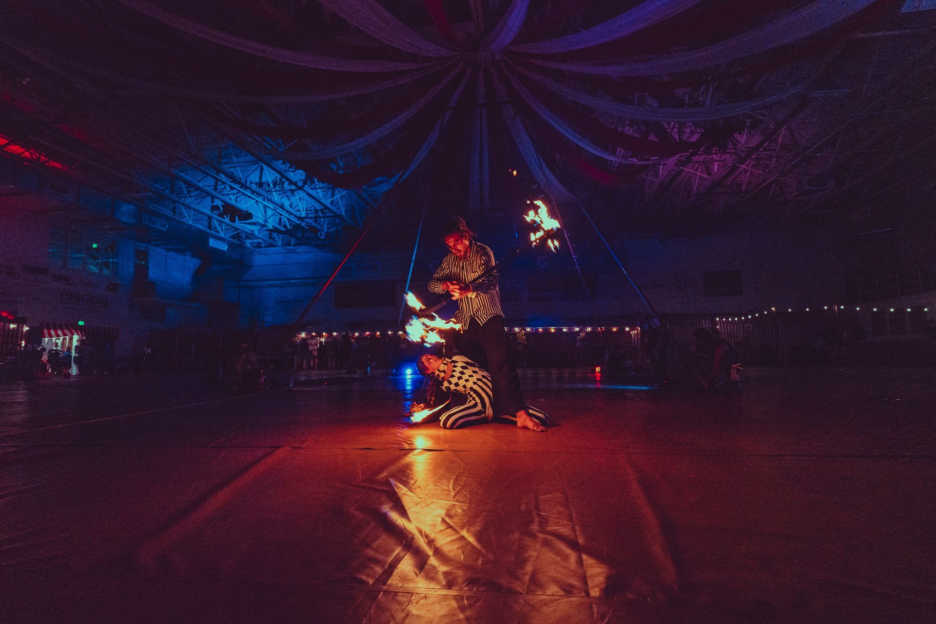 A couple of people are dancing on a dance floor in a dark room.