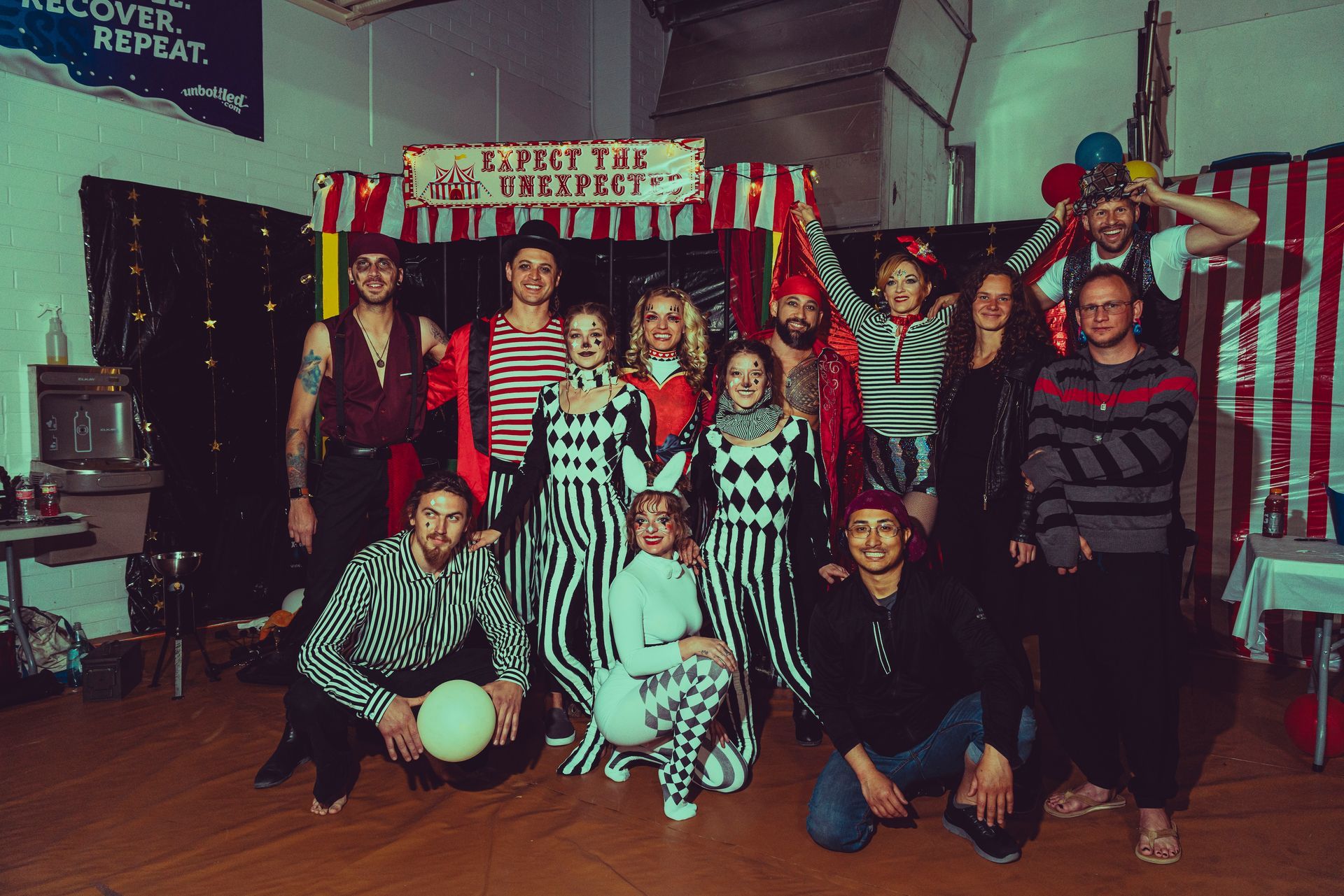 A group of people are posing for a picture in a room.