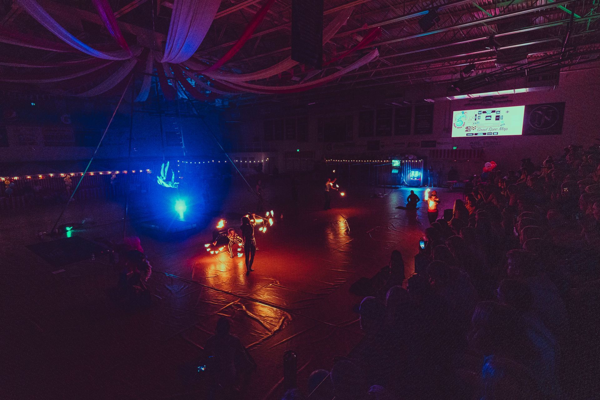 A group of people are standing in a dark room with a lot of lights.
