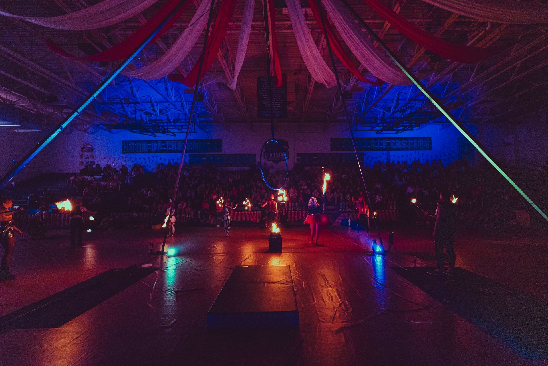 A large room with a lot of lights and a lot of people in it.