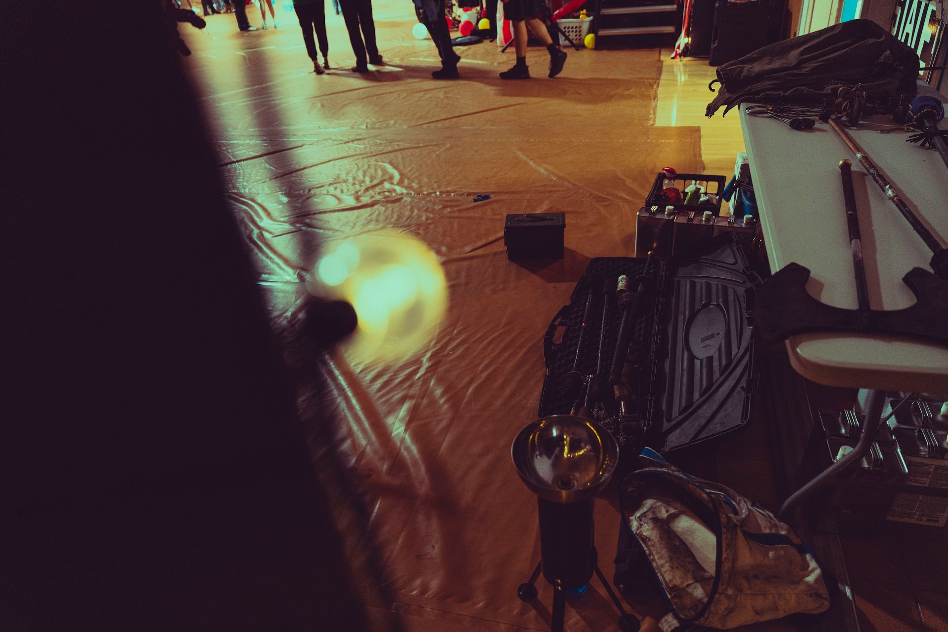 A group of people are walking down a street at night.