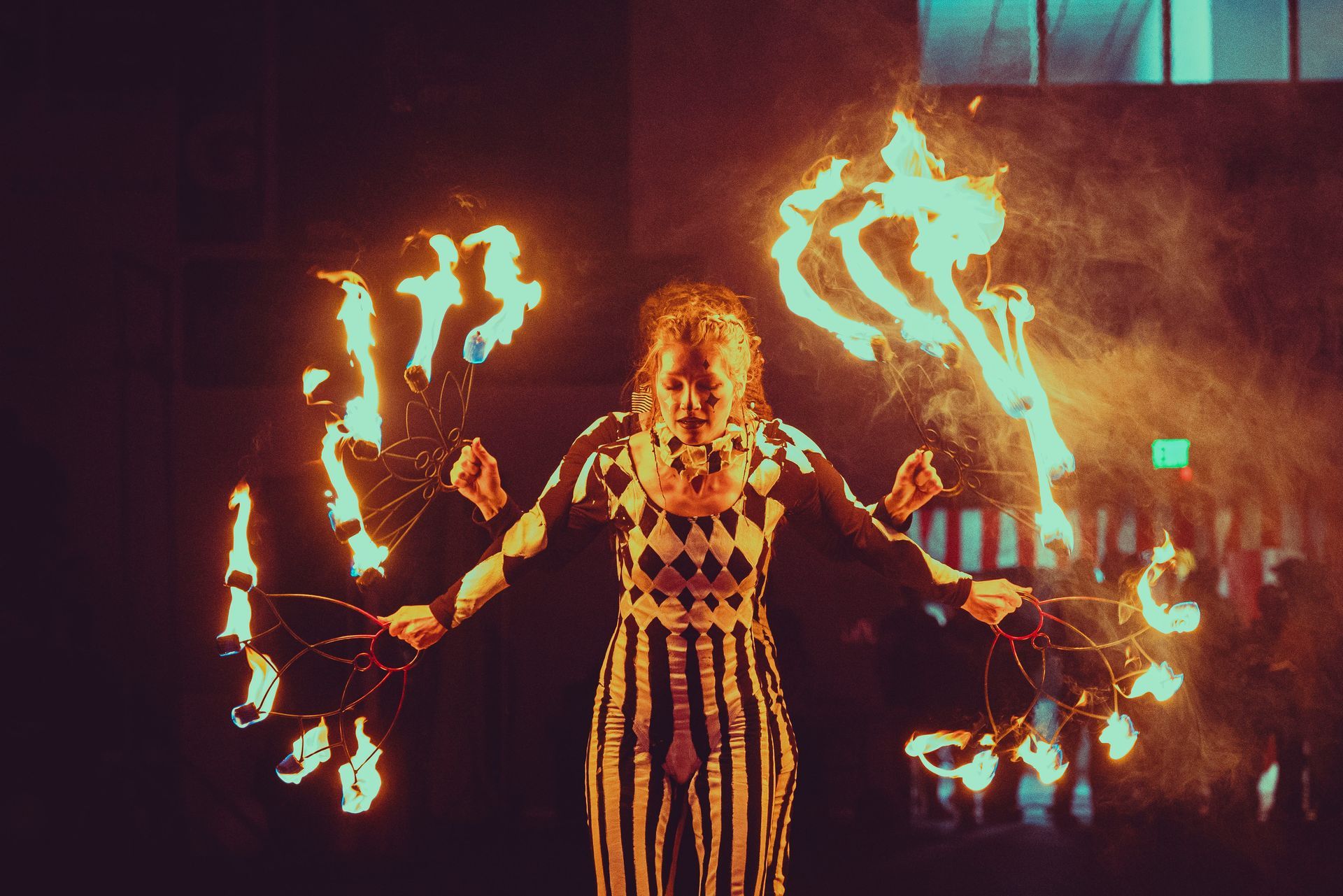 A woman is holding a bunch of fire in her hands.