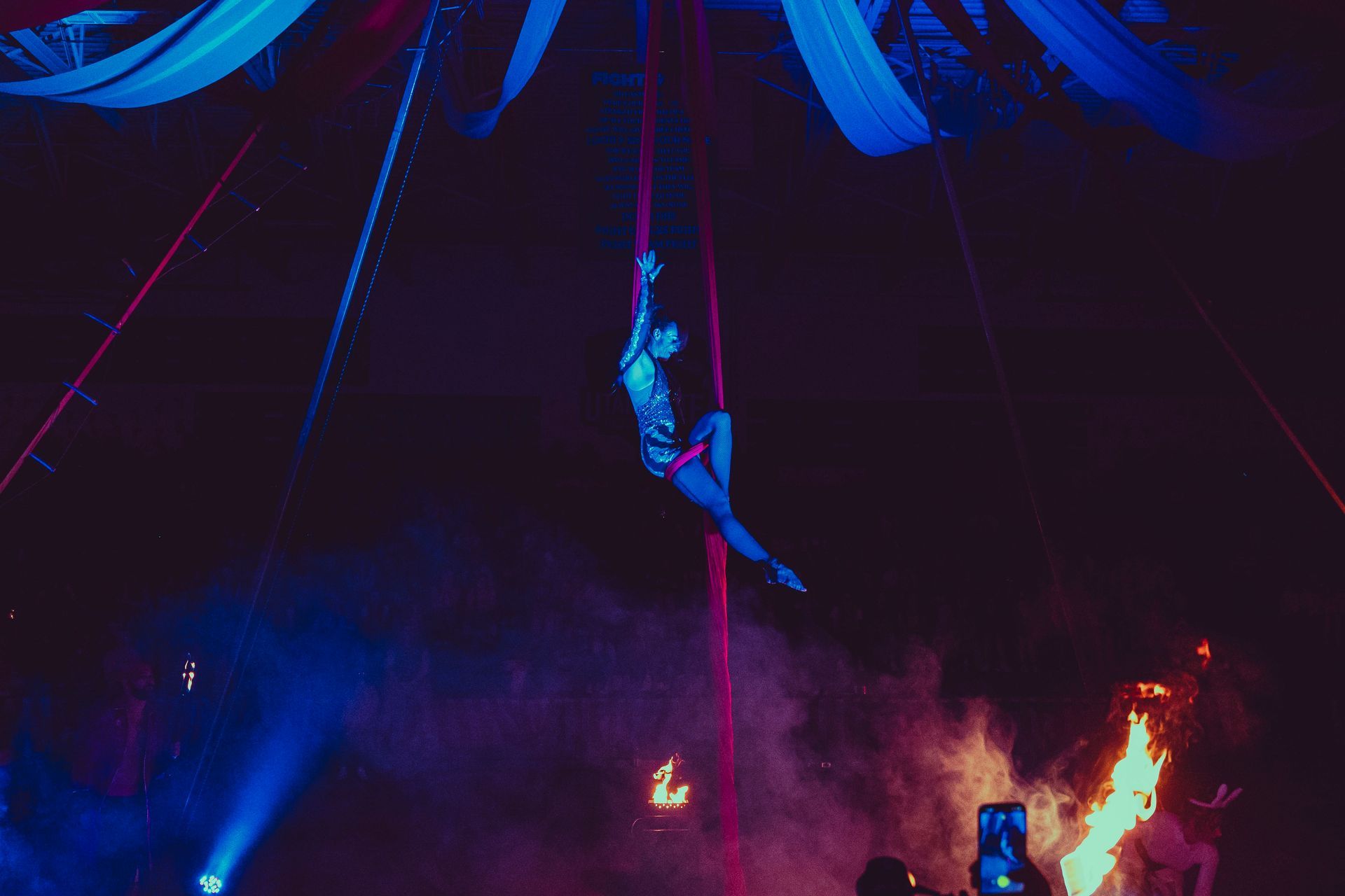 A woman is hanging from a rope in the air.
