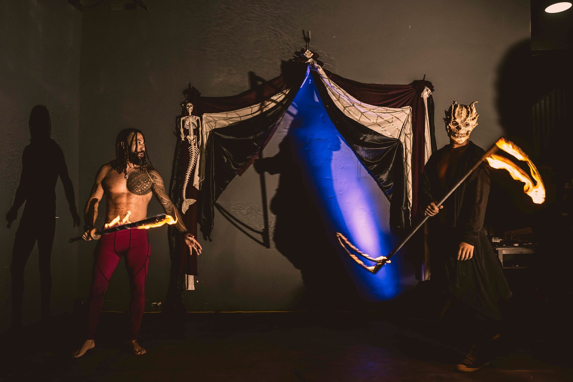 A man is fighting the grim reaper with a fire sword.