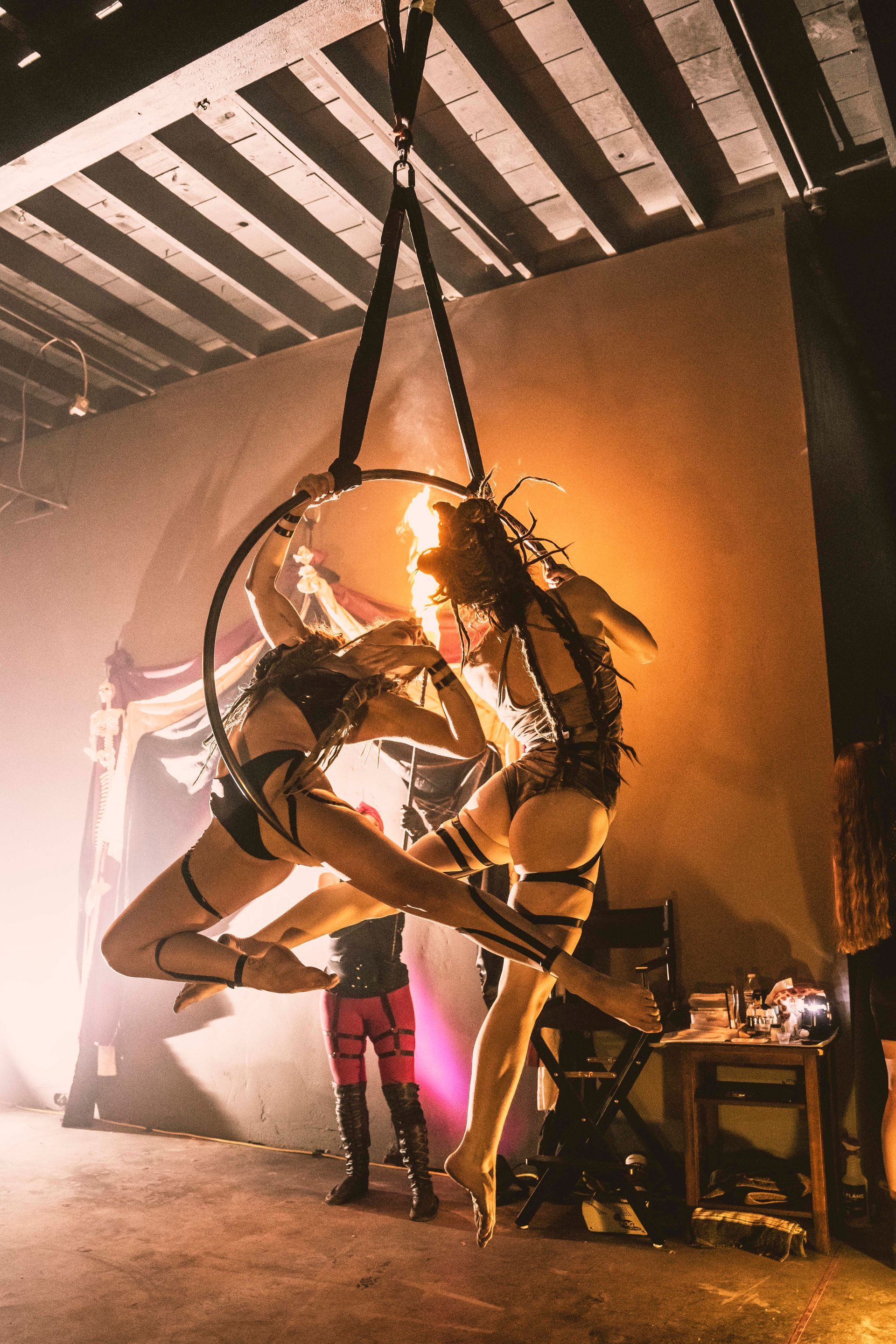 Two women performing on an aerial Lyra at the same time.