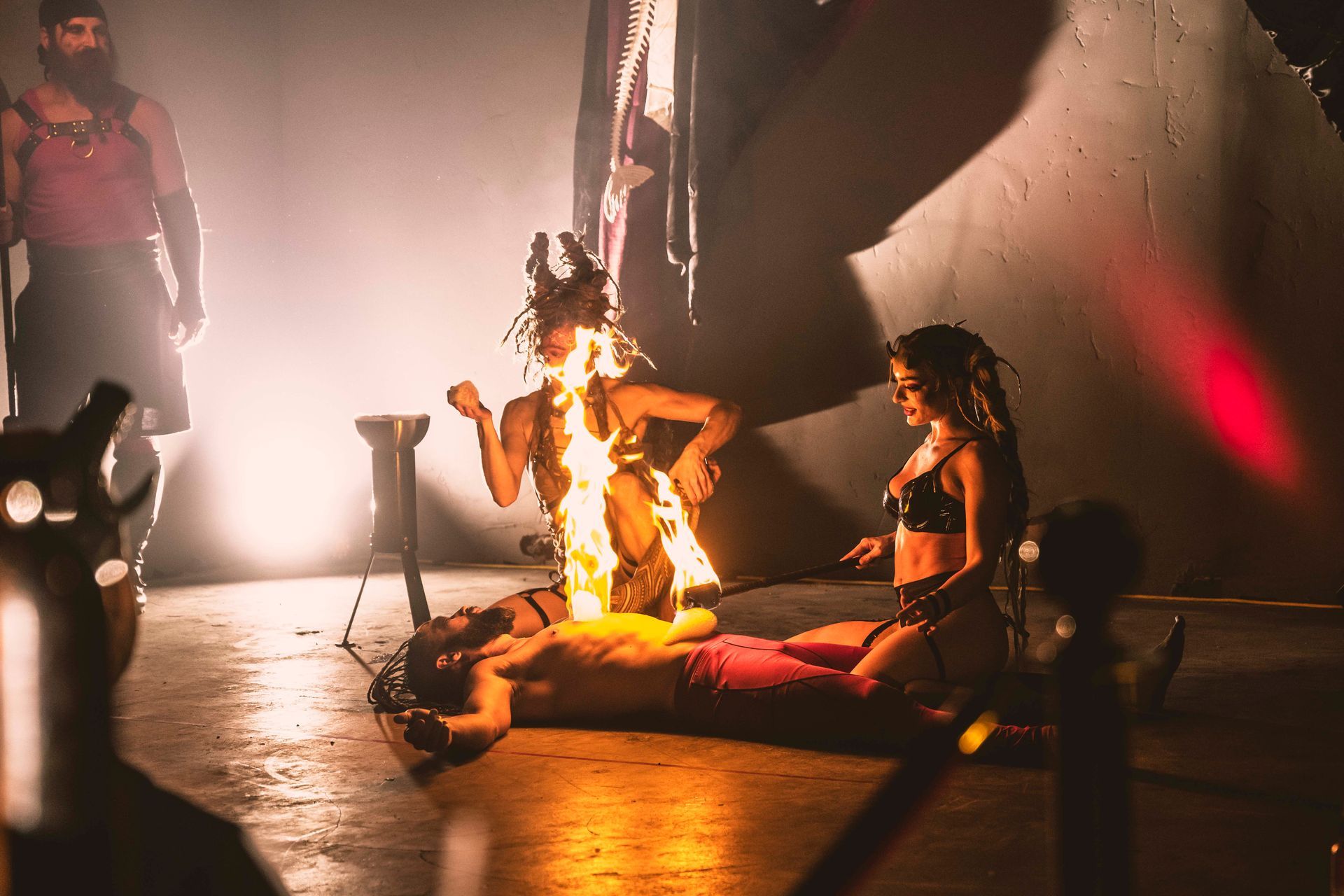 A man is laying on the floor with fire coming out of his chest.