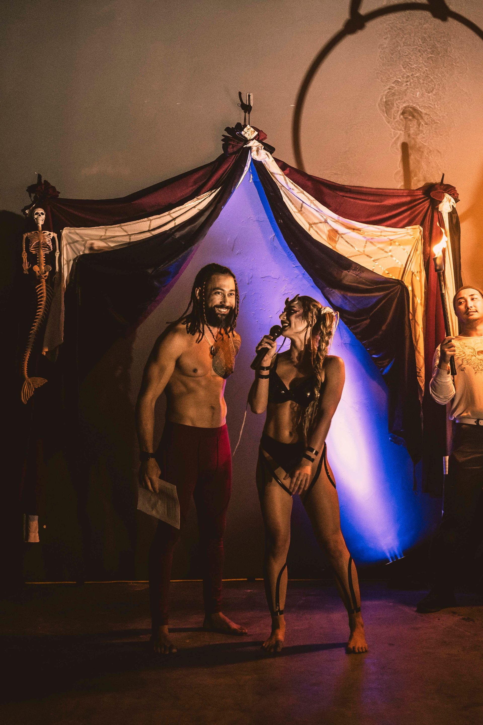 A man and a woman are standing next to each other in a dark room.