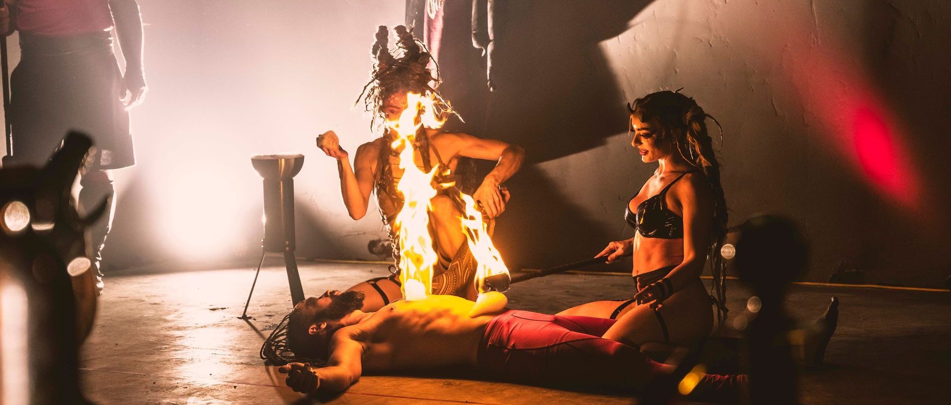 A man is laying on the floor with a woman standing next to him.