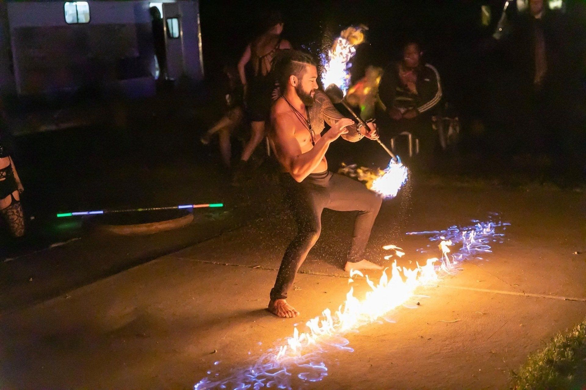 A man is playing a violin with flames coming out of it.