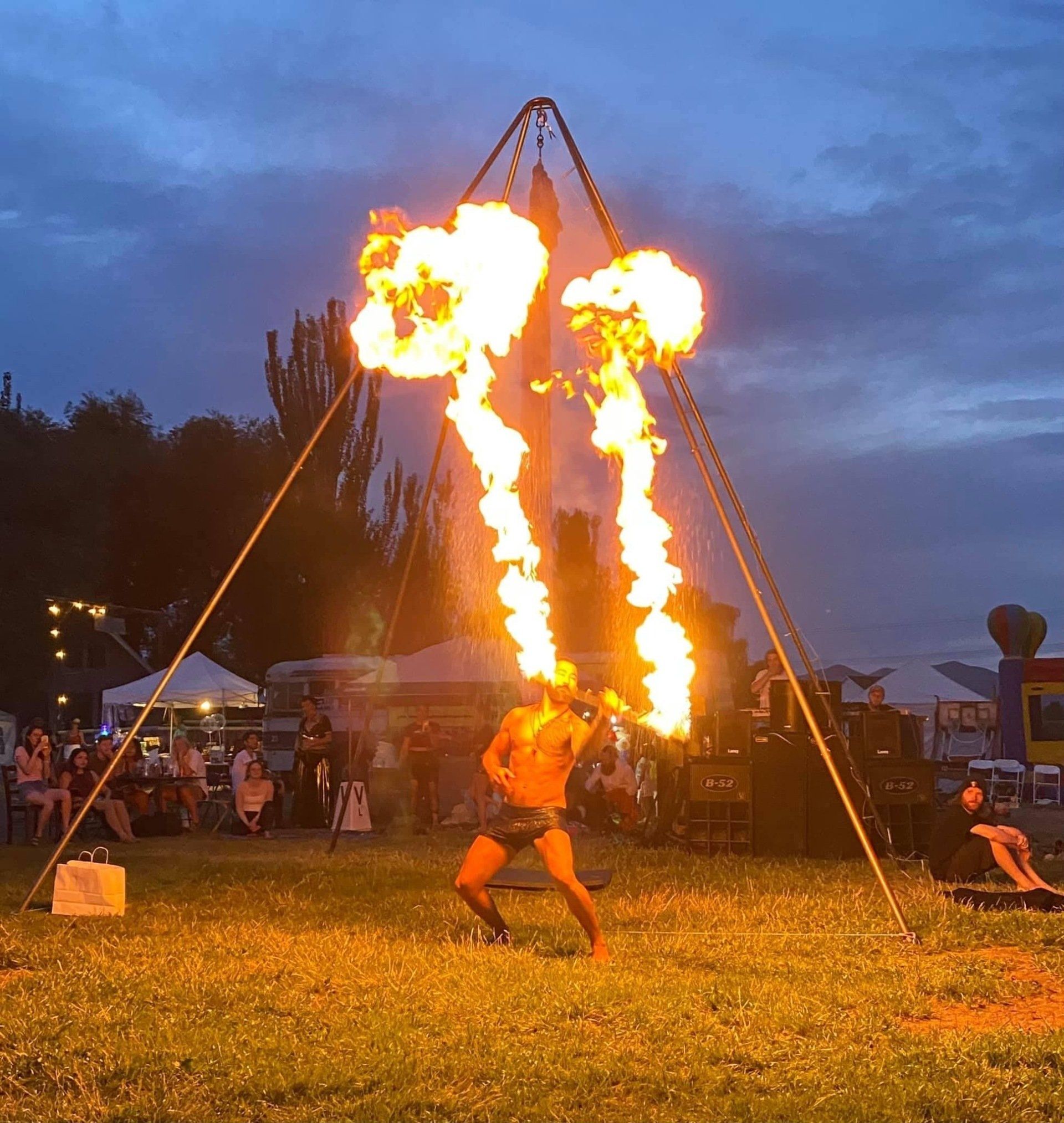 A man is performing a stunt with flames coming out of his mouth