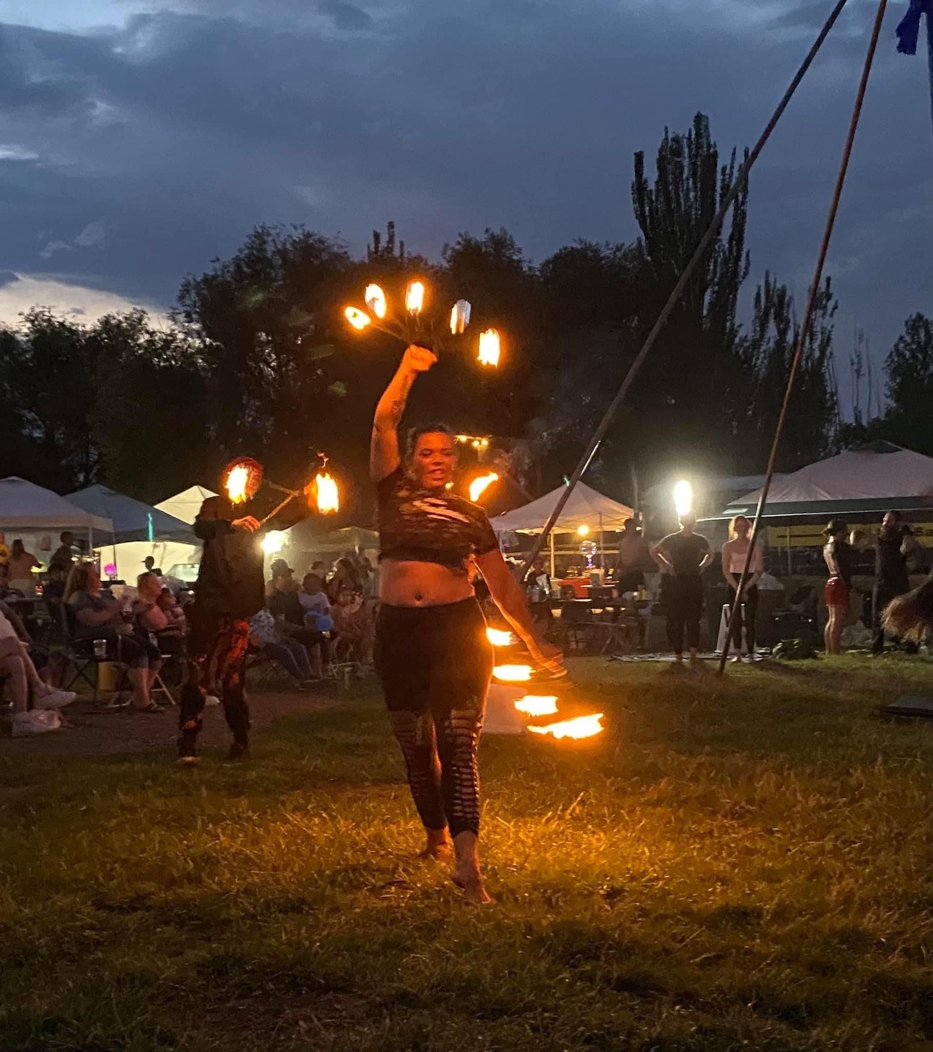 A woman is holding a bunch of fire in her hands