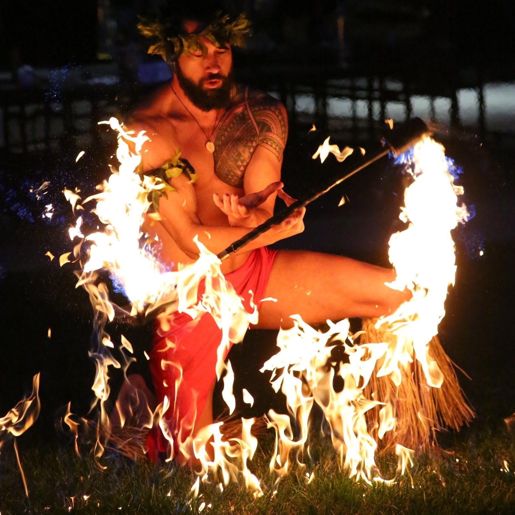 A man with a beard is playing with fire