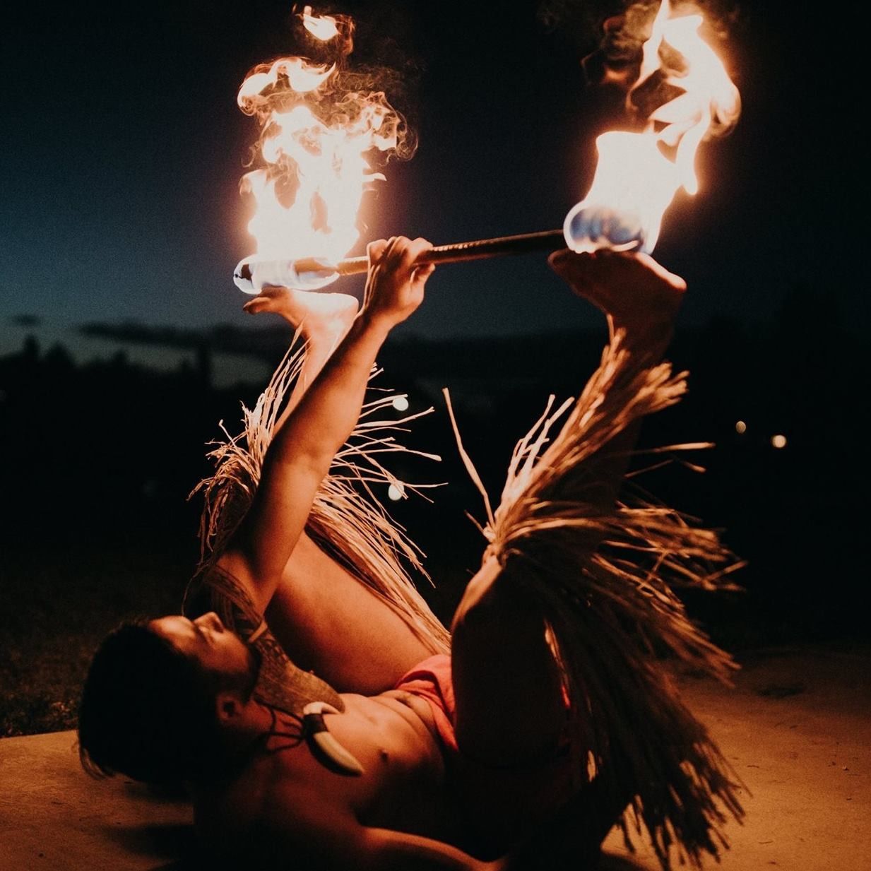 A man is holding a torch with flames coming out of it