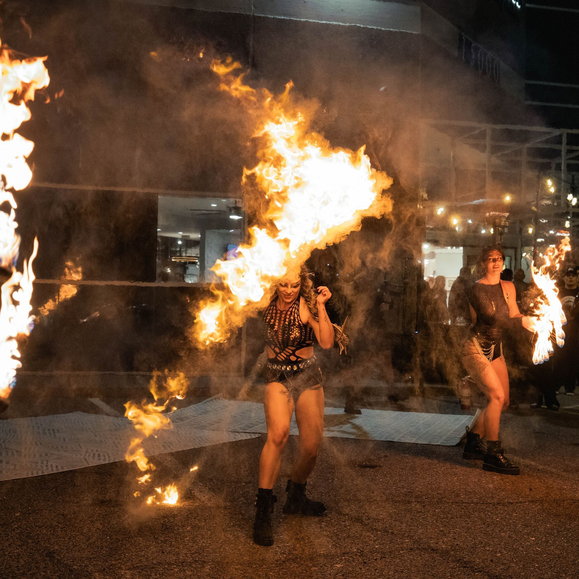 A woman is holding a torch with flames coming out of it
