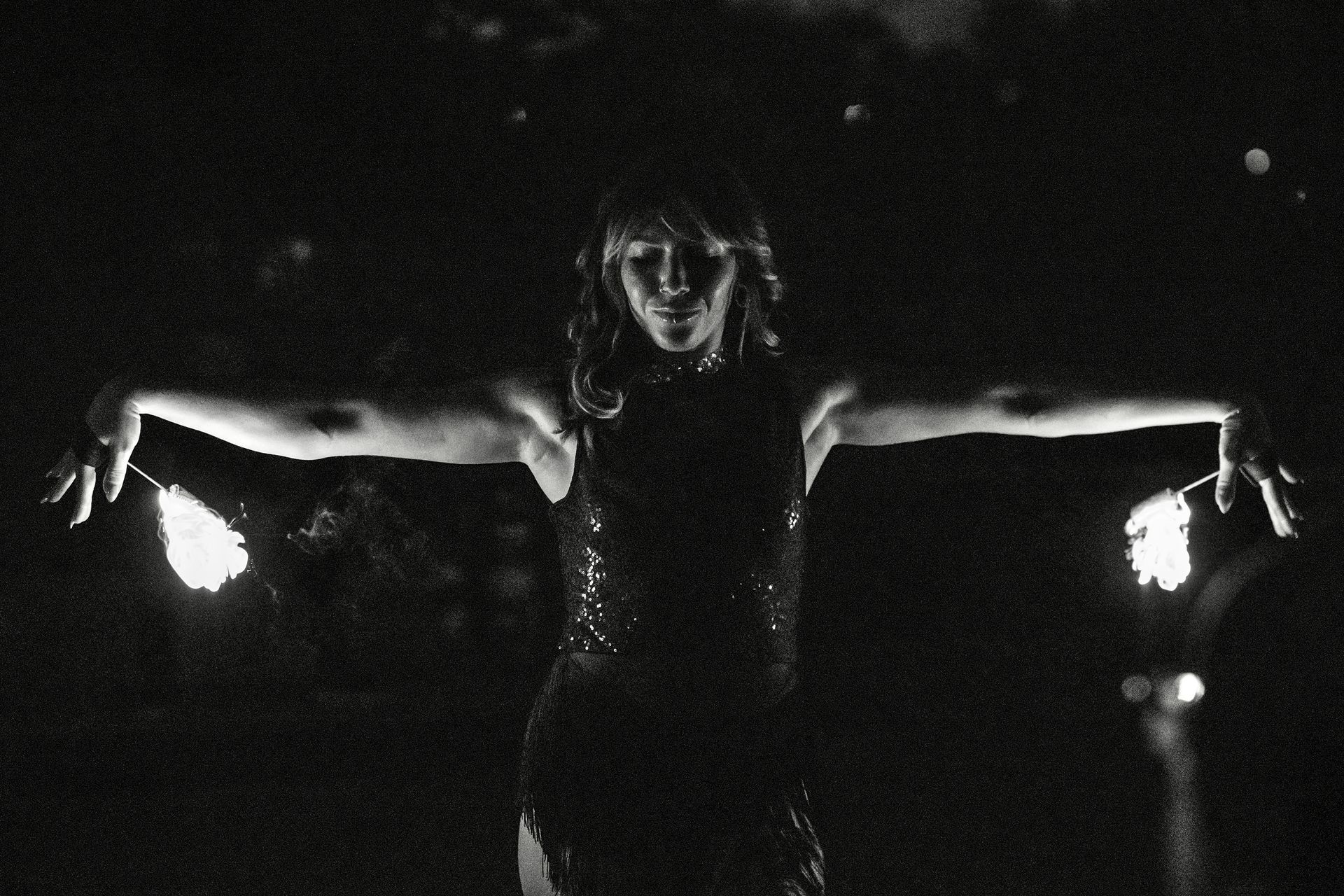 A black and white photo of a woman with her arms outstretched