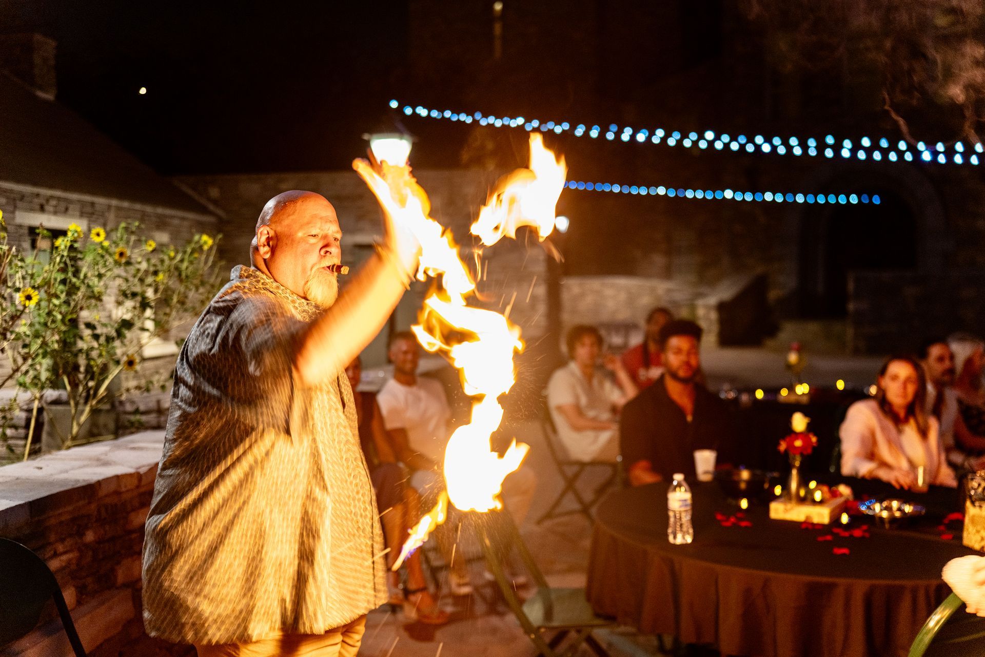 A man is holding a torch in front of a crowd of people.