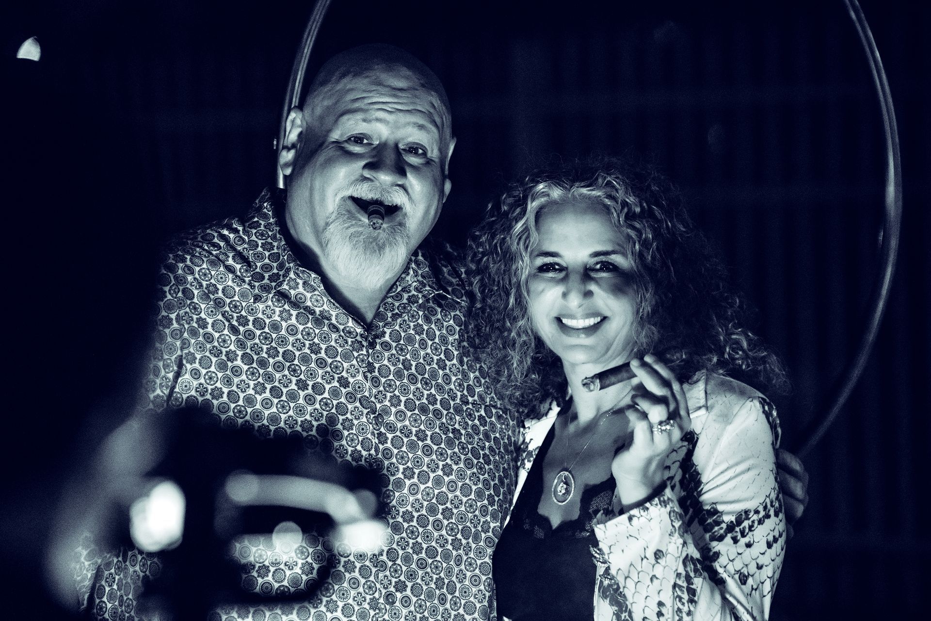A man and a woman are posing for a picture in a black and white photo.