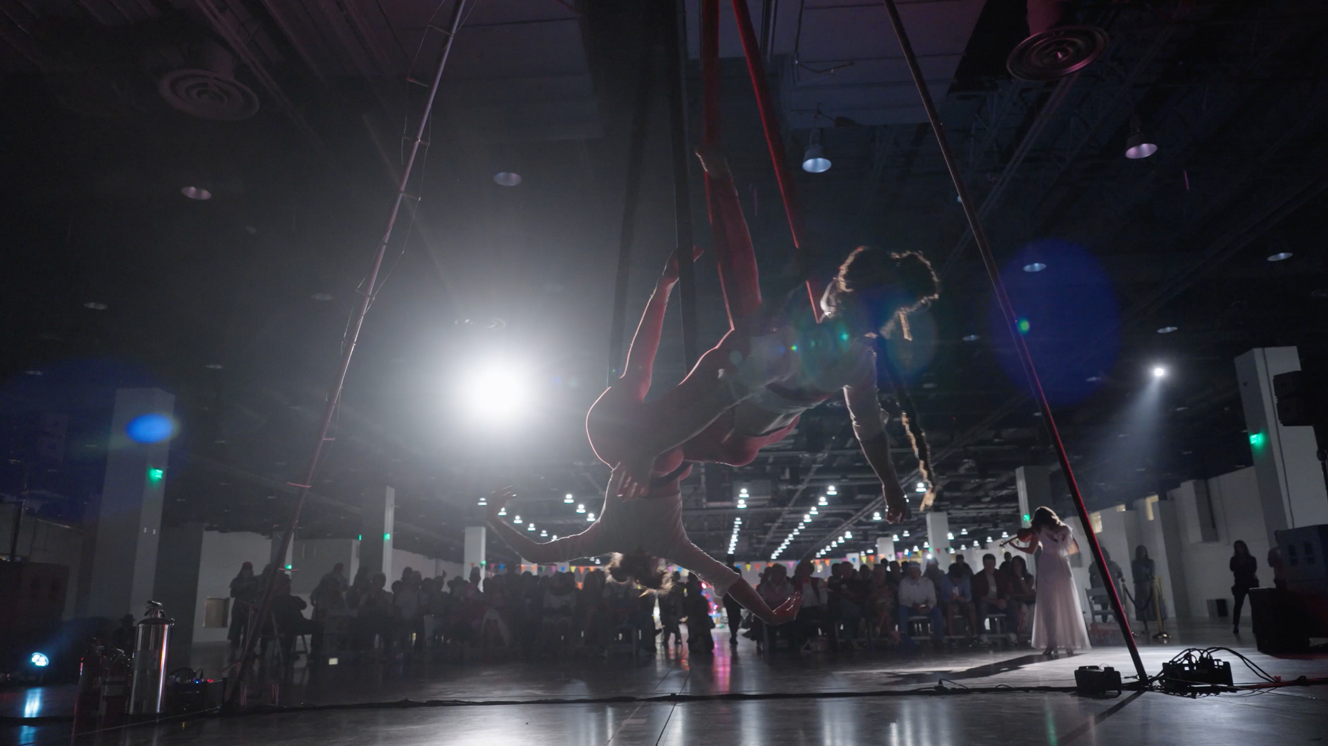 A group of people are standing in a dark room with a large object hanging from the ceiling.