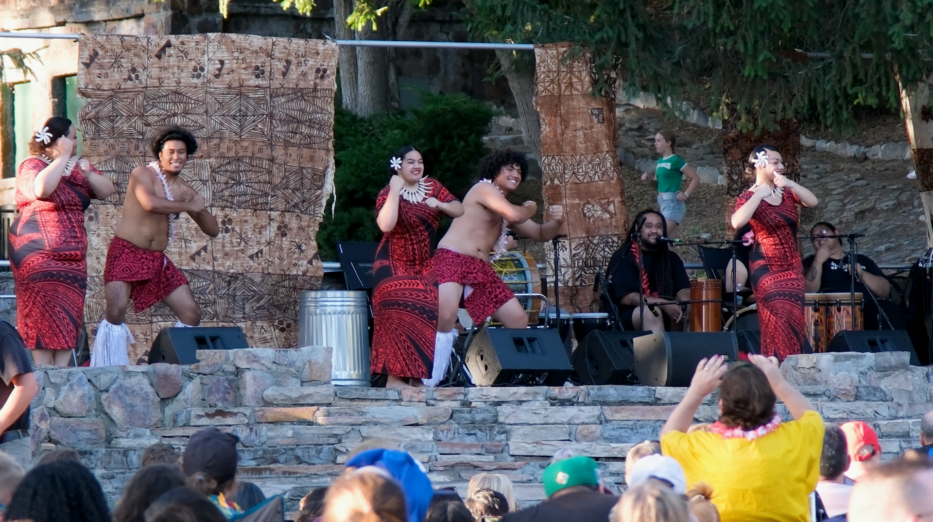 A group of people are dancing in front of a crowd