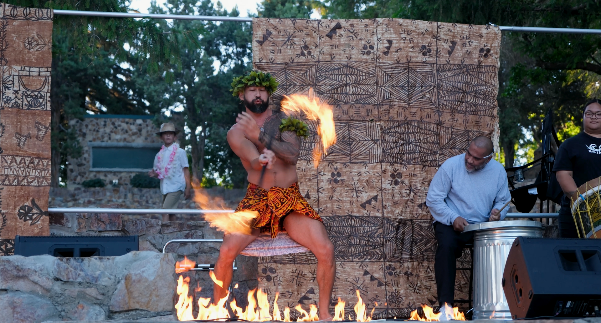 A man is holding a fireball in his hand while dancing.