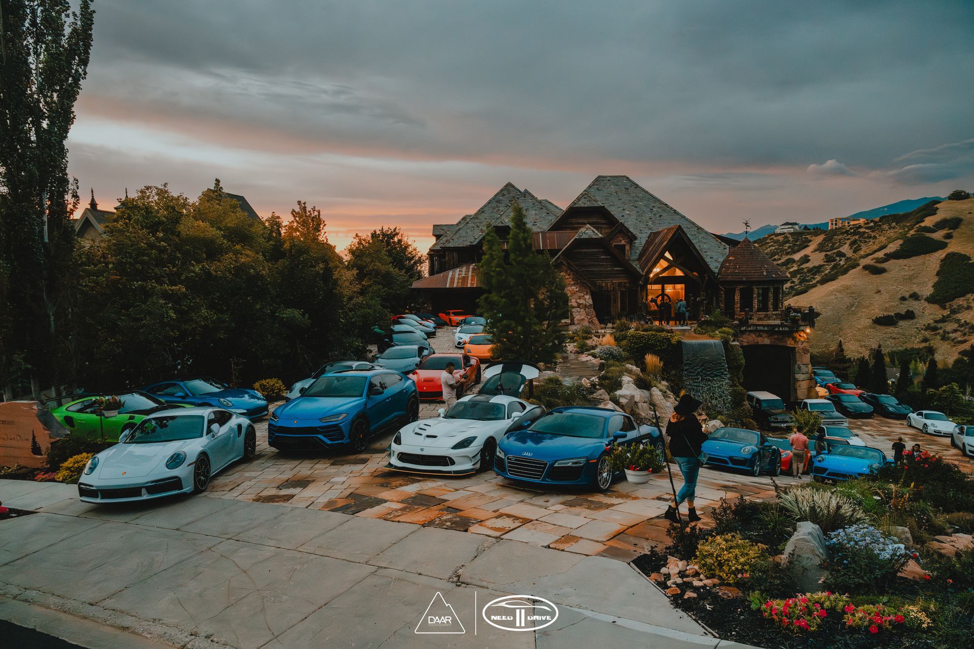 A bunch of cars are parked in front of a house.