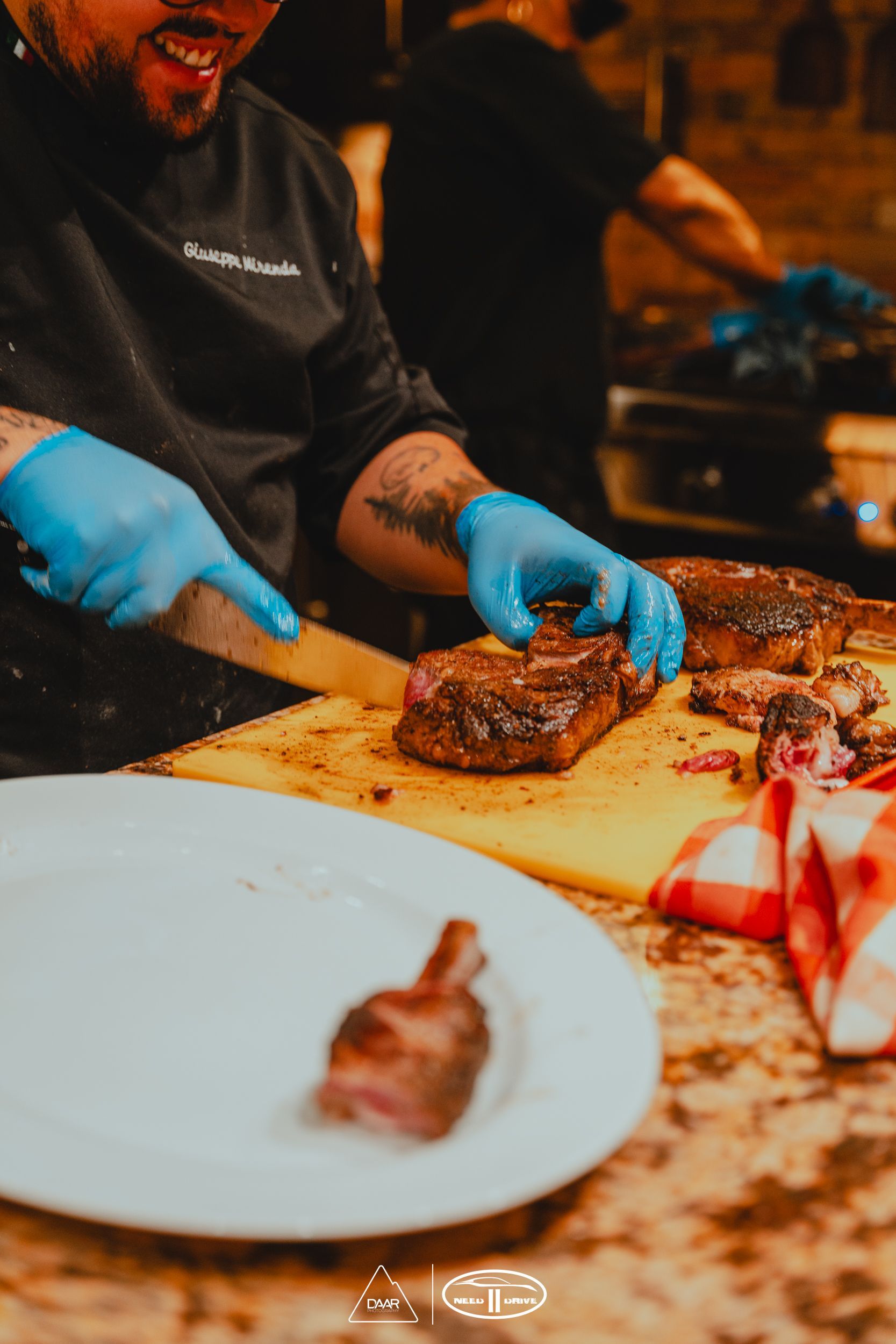 A man is cutting a piece of meat on a cutting board.