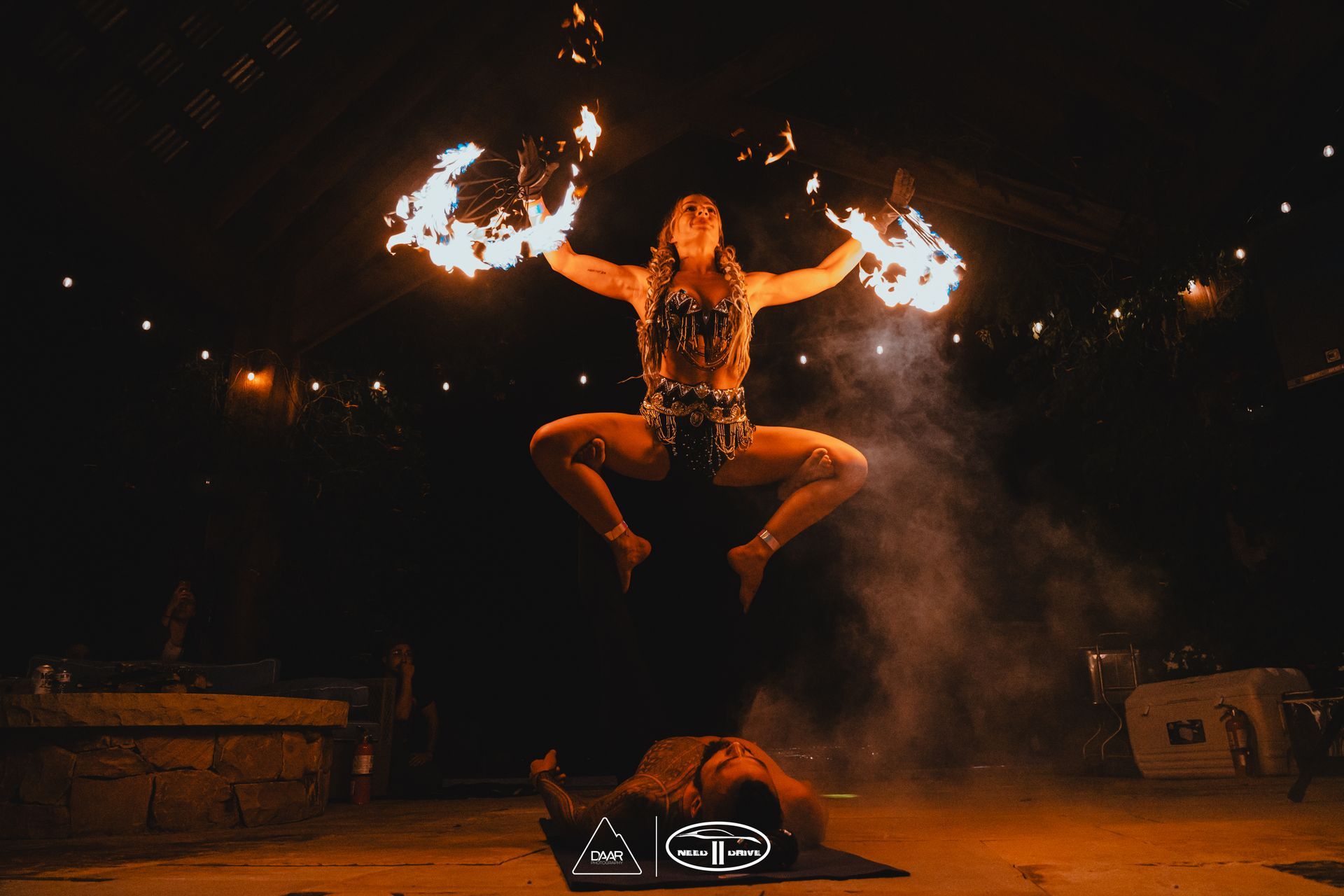 A man and woman performing acrobatic fire.