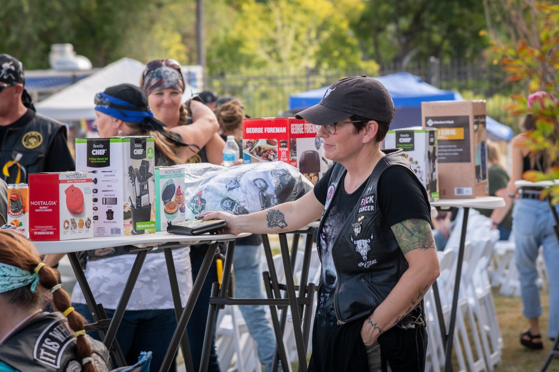 A woman is standing in front of a table with boxes on it.