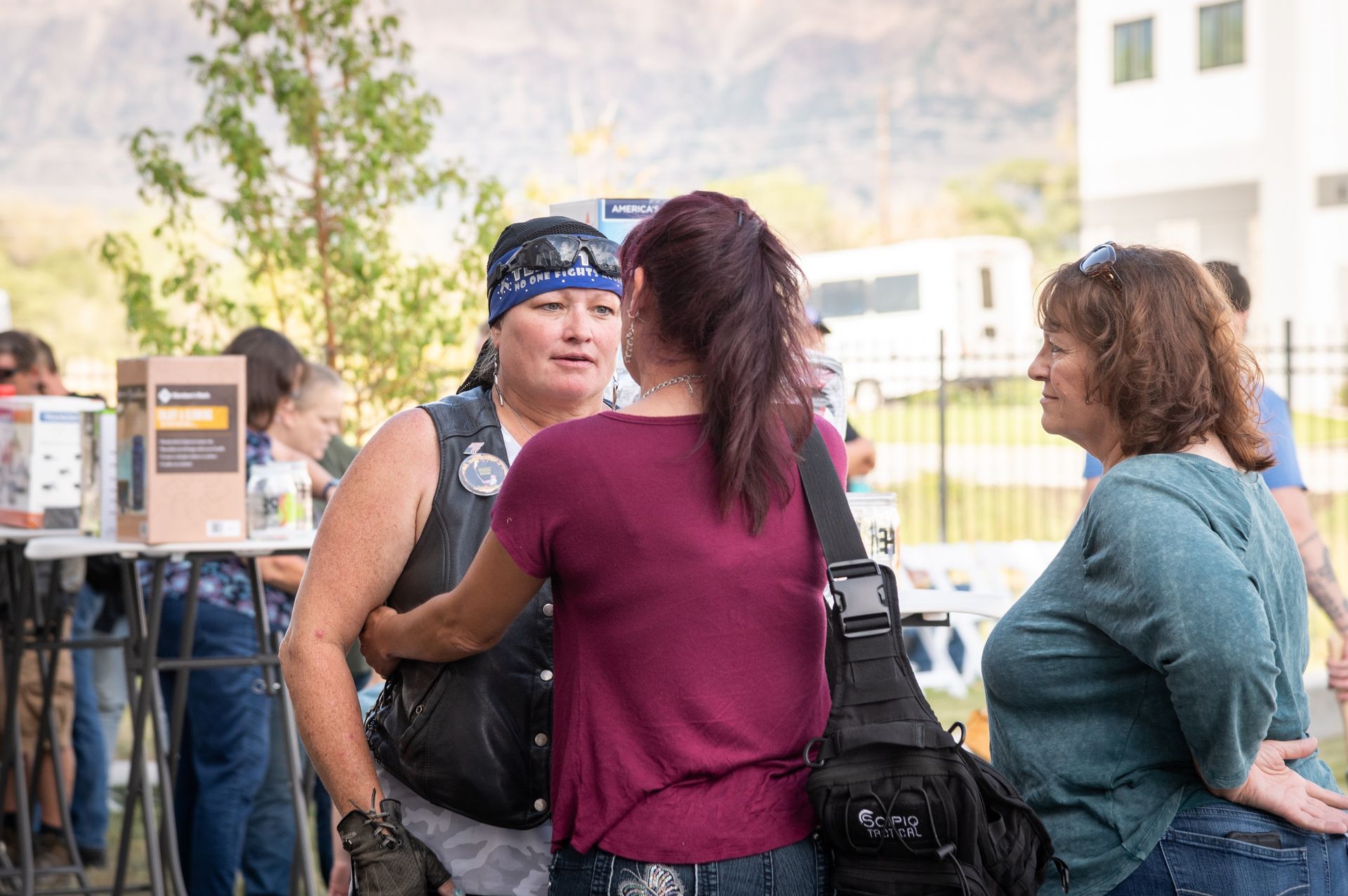 A group of women are standing next to each other talking to each other.