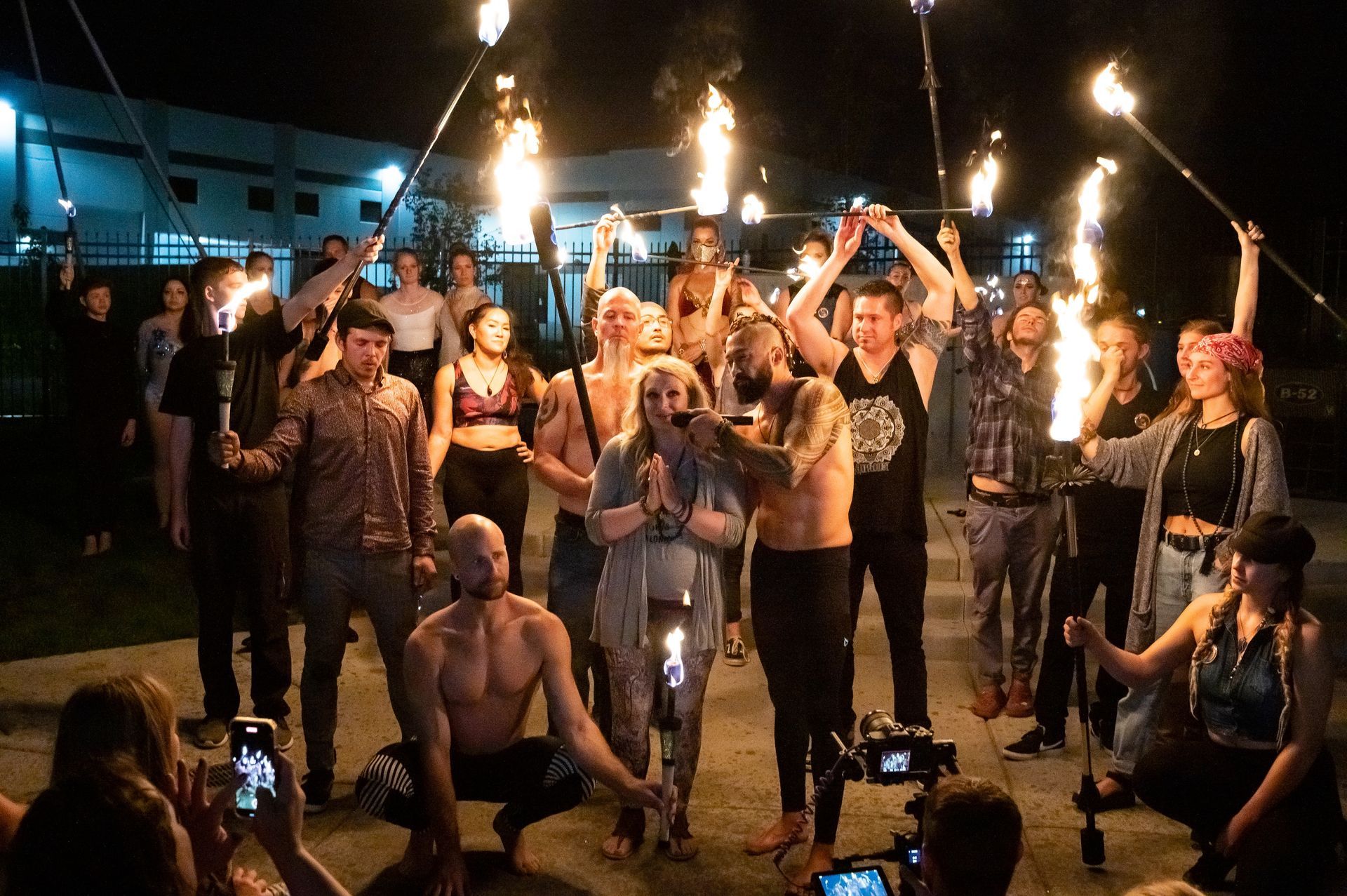 A group of people are holding torches in their hands.