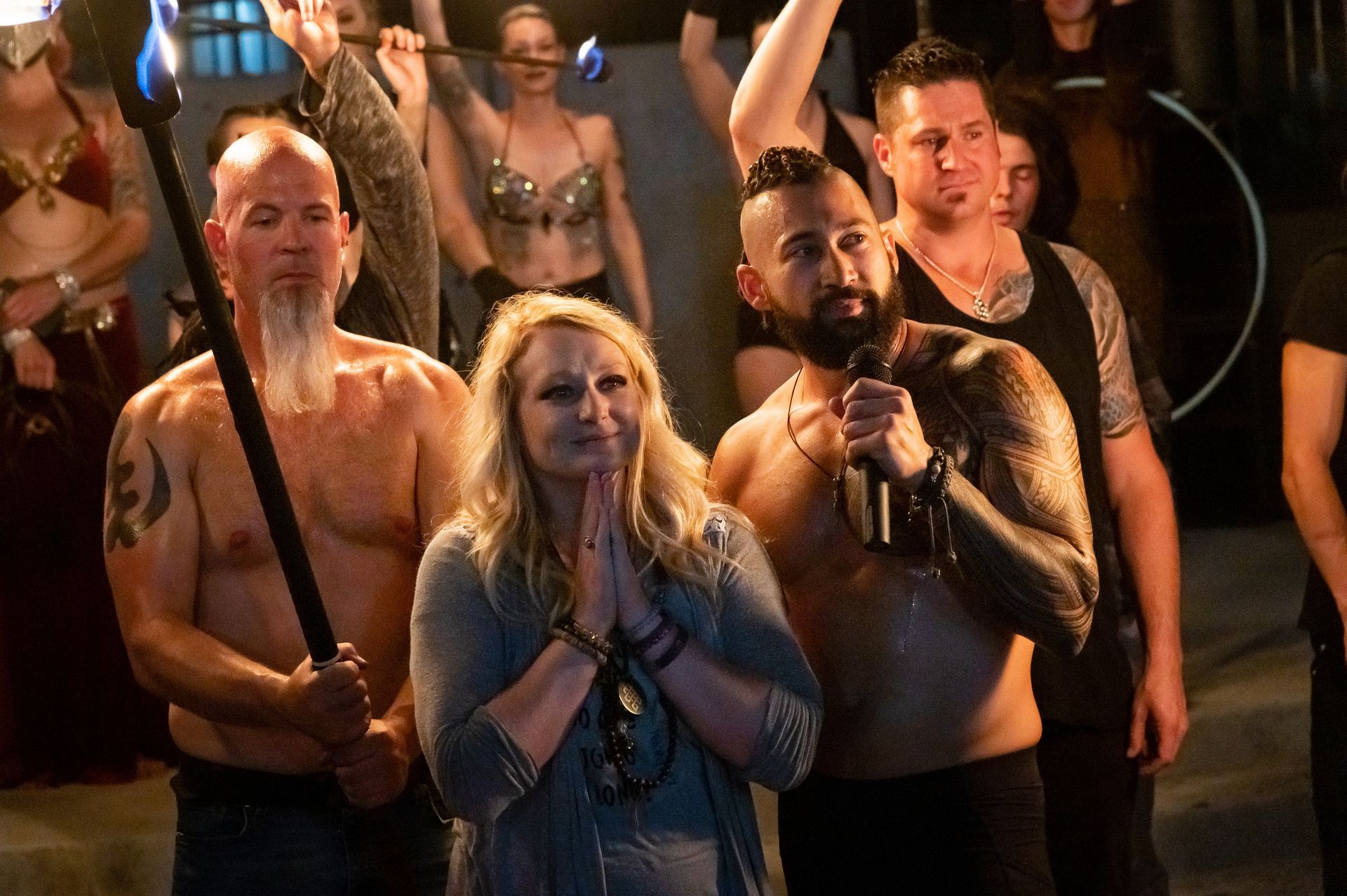 A group of people standing next to each other holding torches.