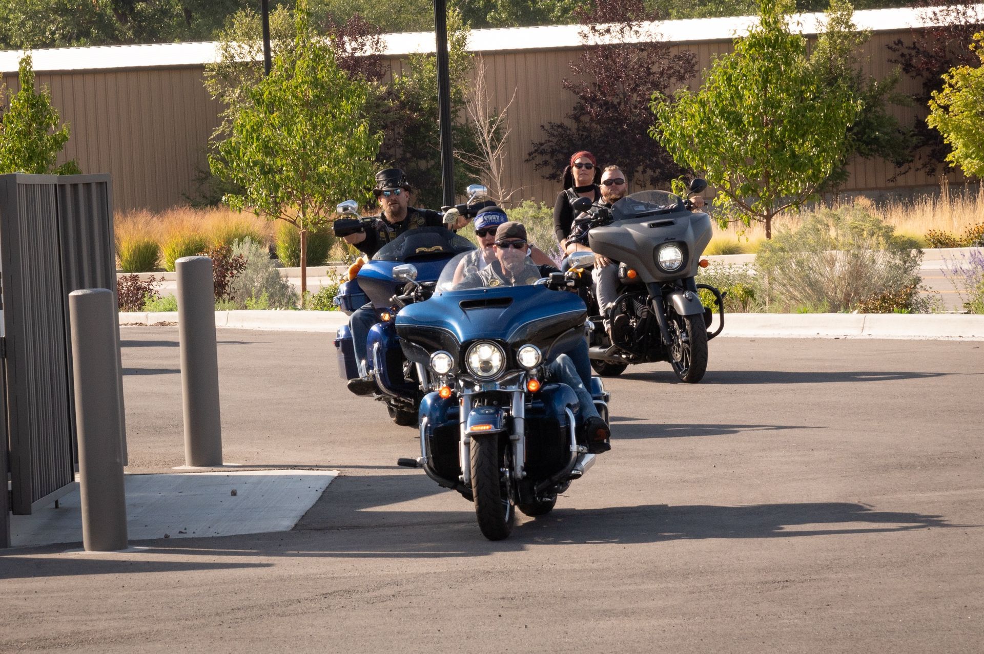 A group of people are riding motorcycles down a street
