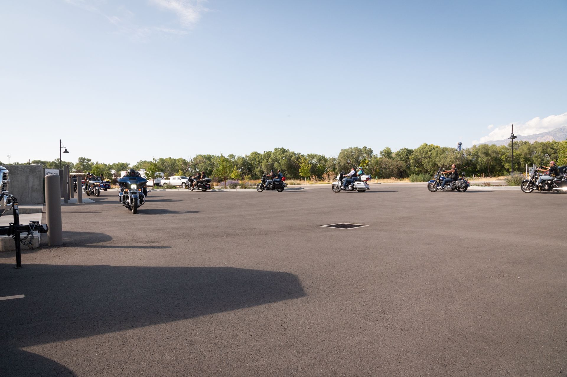 A group of people riding motorcycles in a parking lot