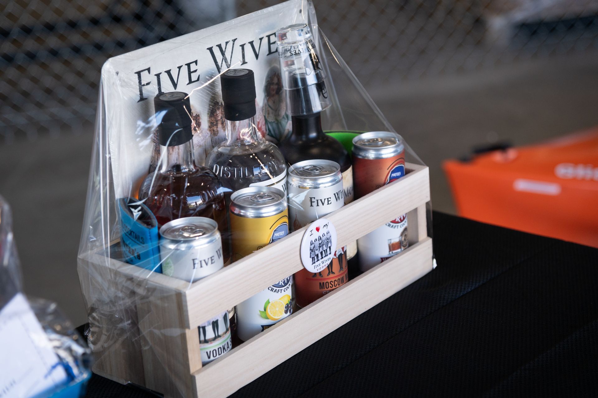 A wooden crate filled with bottles and cans of beer.