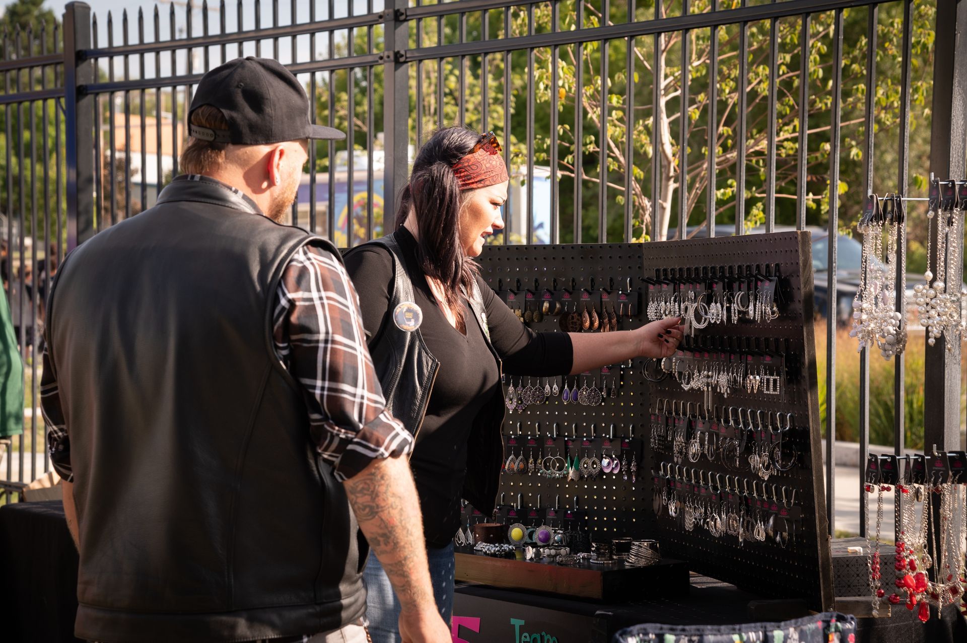 A man and a woman are looking at a display of jewelry.