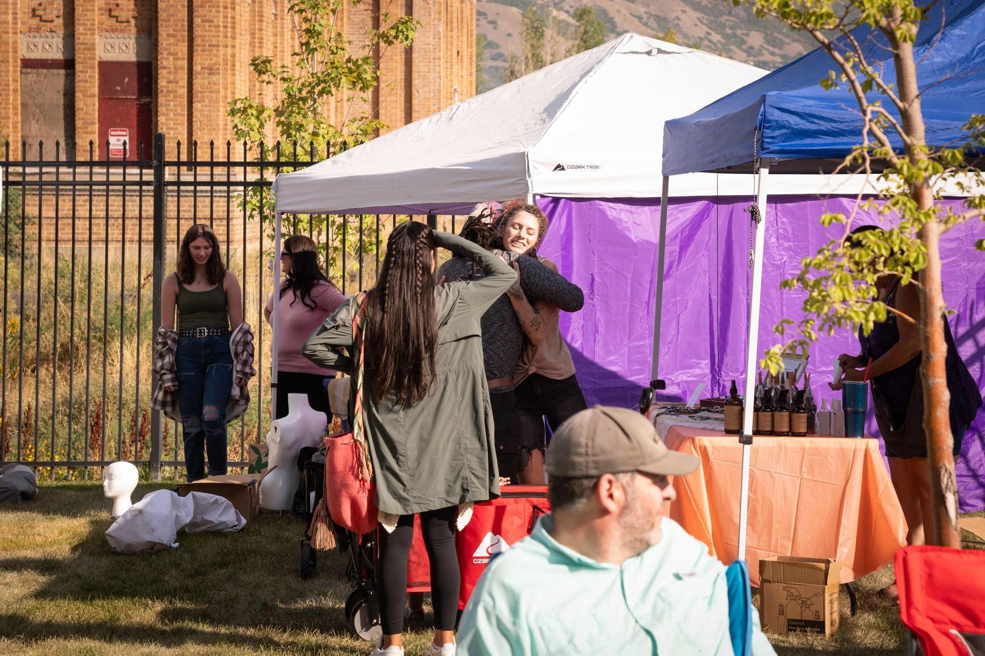 A group of people are standing in front of a tent.